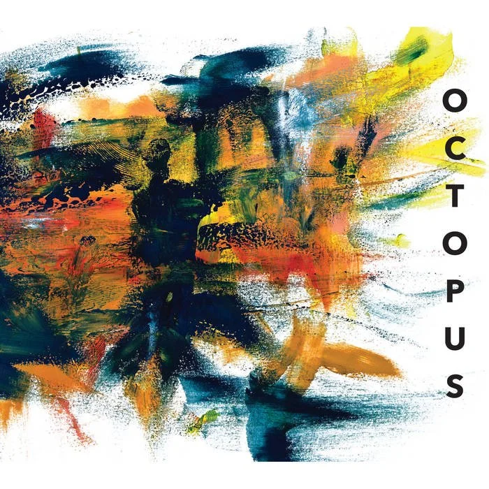 Abstract watercolor painting with vibrant splashes of yellow, orange, green, and dark blue, featuring the words "OCTOPUS" arranged vertically on the right side.
