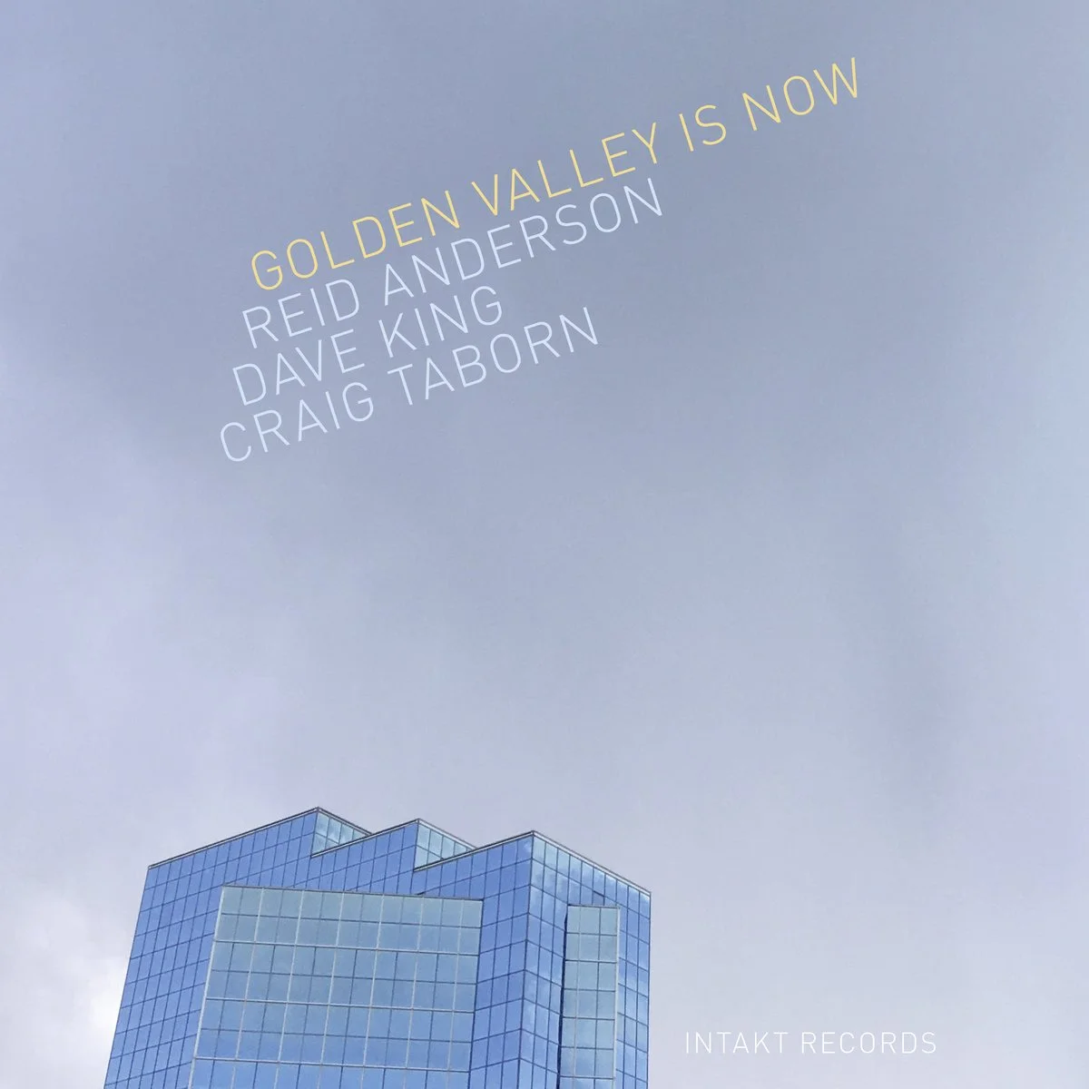 An album cover with a light blue sky, a modern glass building at the bottom, and yellow and white text listing artist names and album title.