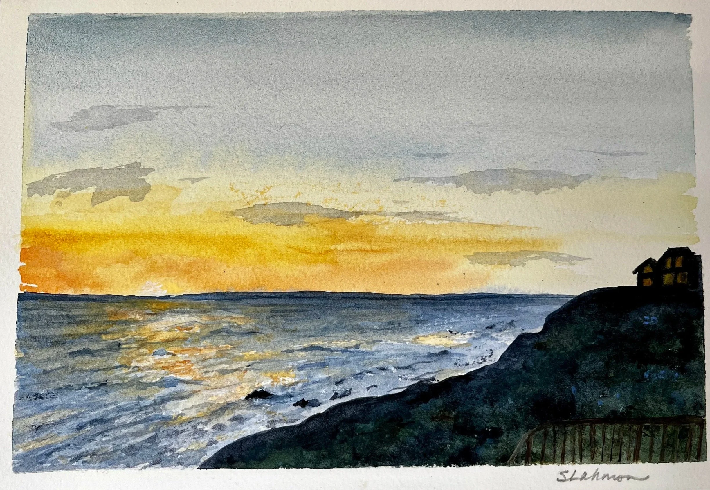 Watercolor painting of a sunset over the ocean with a house on the rocky shore to the right.