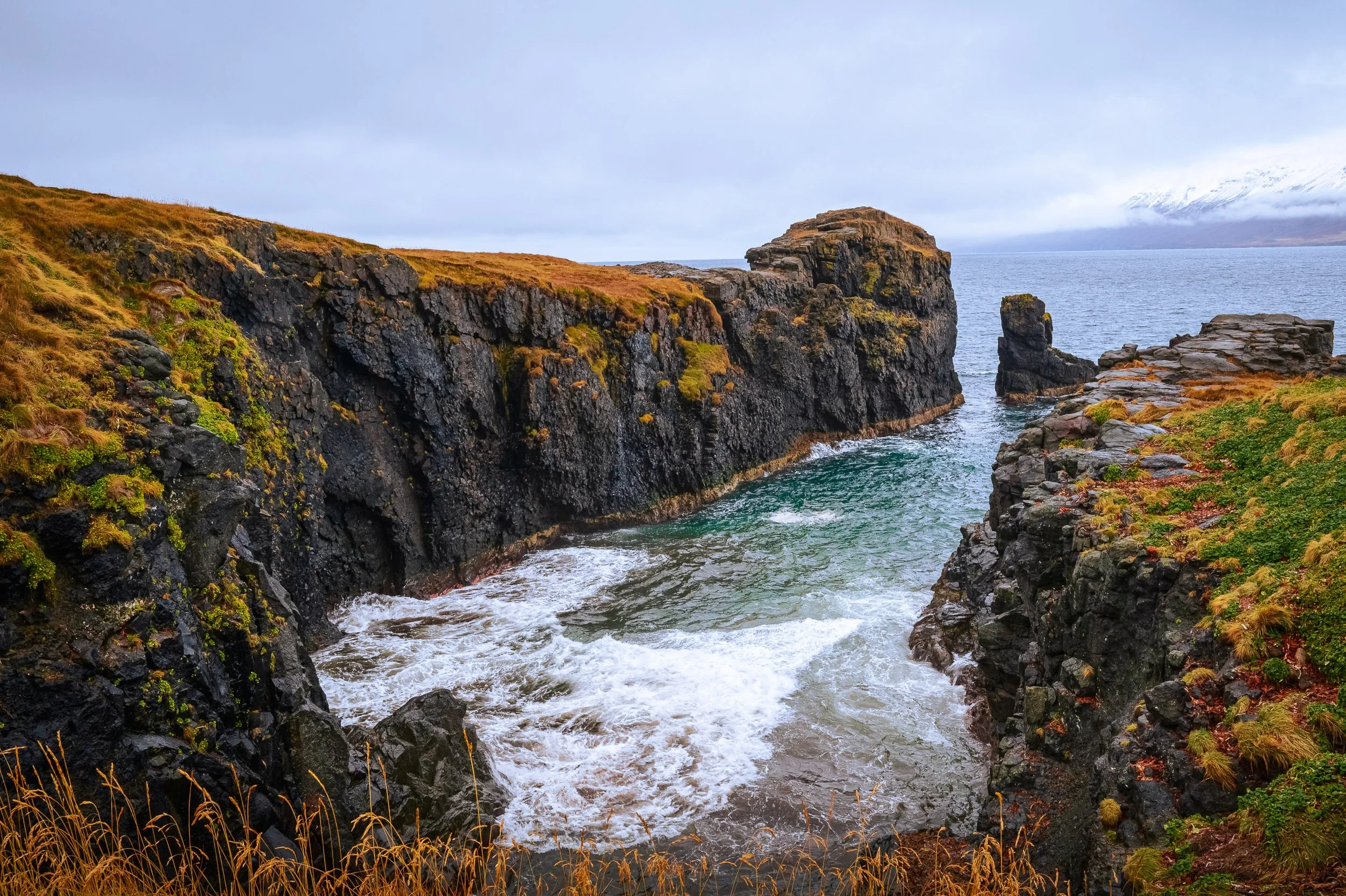 Rock and Sea

Rugged basalt cliffs and a narrow sea inlet on Hrísey Island in northern Iceland, with cold Norwegian/Greenland Sea waters beneath overcast skies.