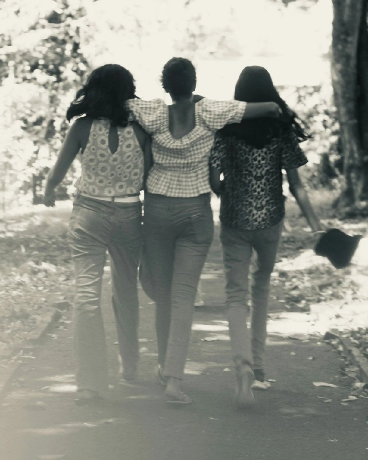 Three women happily walking together