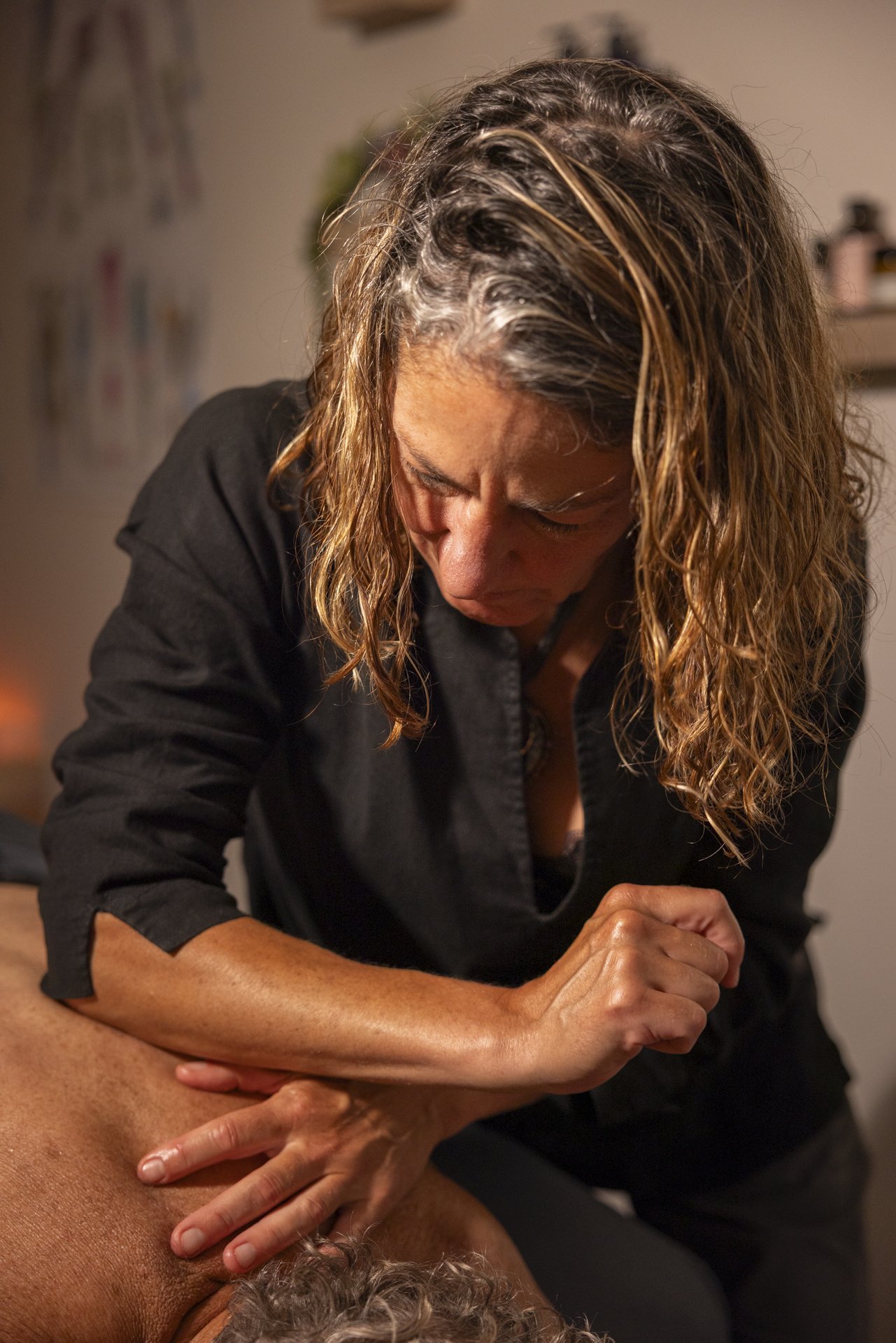 Dr. Decker is shown giving deep tissue massage using her elbow on her client's back