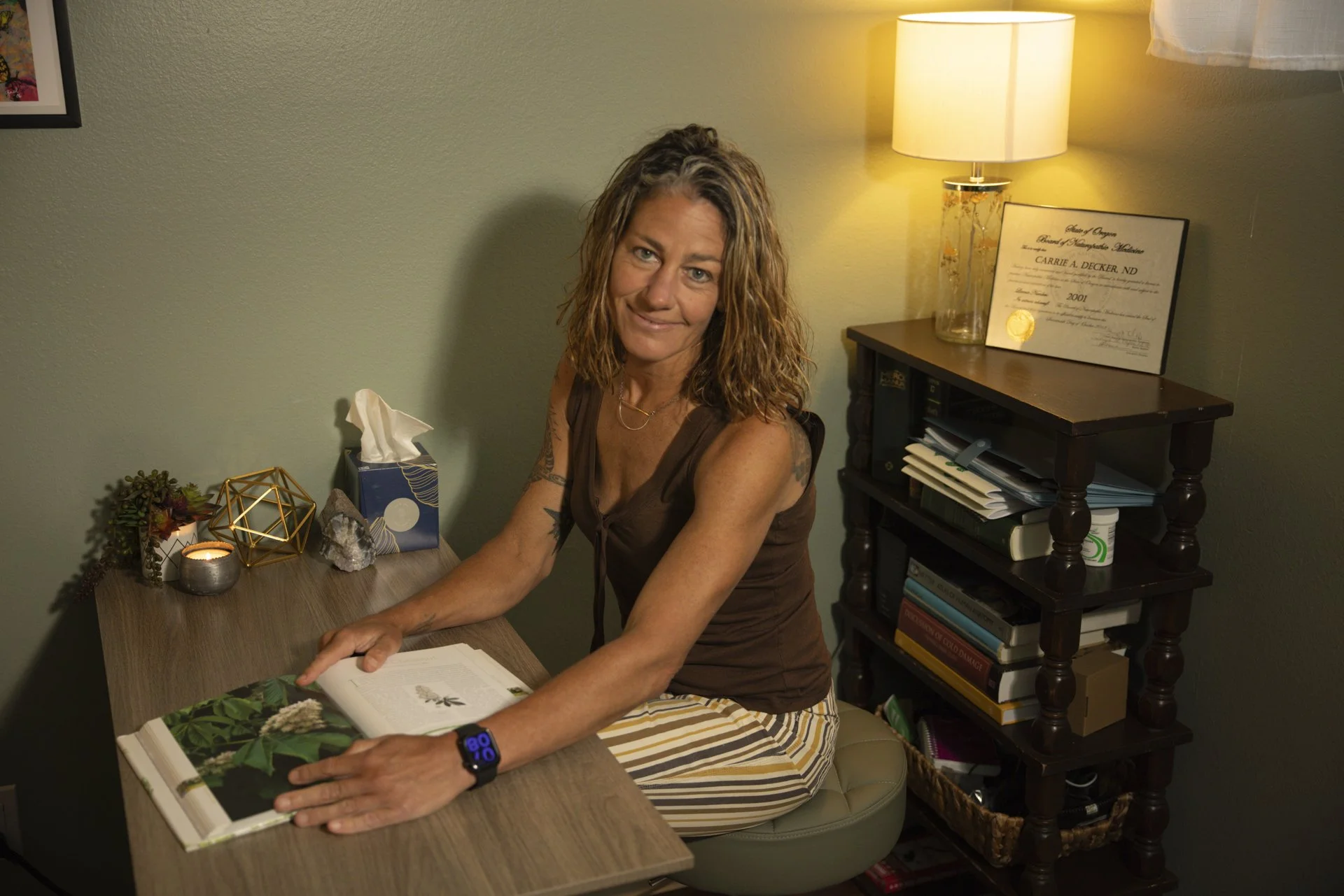 Image shows Dr. Decker sitting at her desk while she is doing a  remote telehealth consultation.
