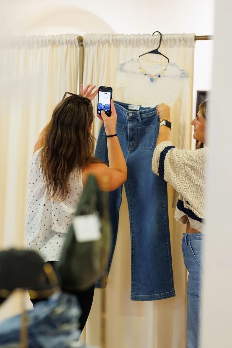 Individual takes photo of outfit.