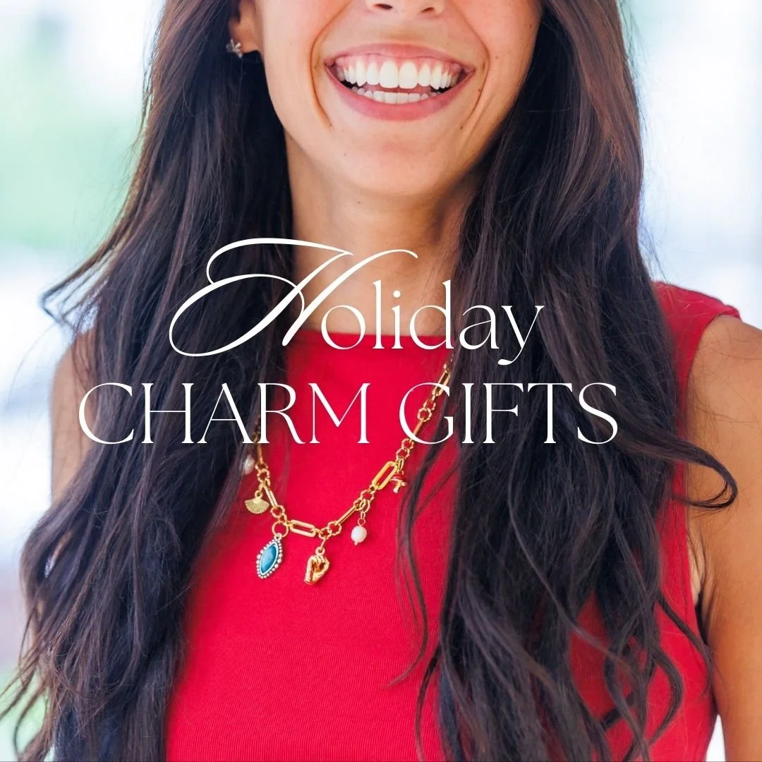 Close-up of a smiling woman wearing a red top and a gold charm necklace, with the text 'Holiday Charm Gifts' overlayed.