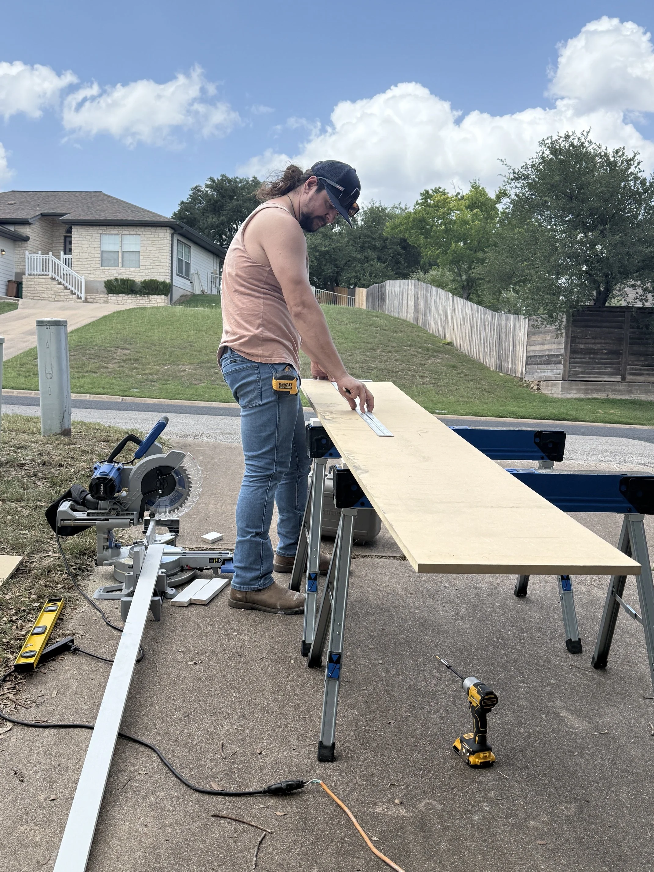 Grady measuring and cutting custom shelves