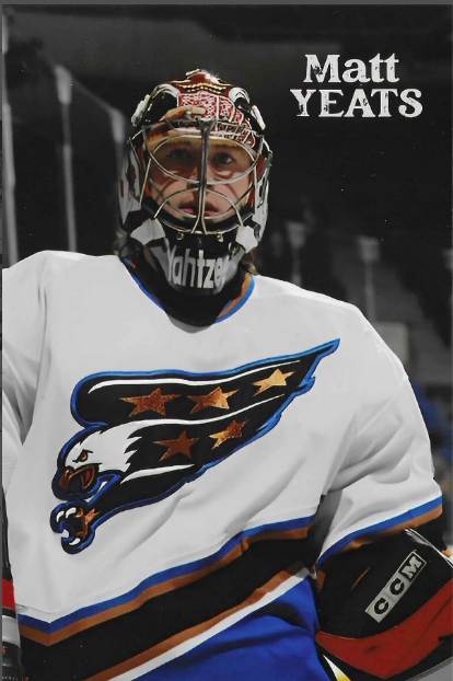Hockey player wearing a white jersey with a shark logo, black goal mask, and gloves, standing on the ice. Text reads "Matt Yeats" in the upper right corner.