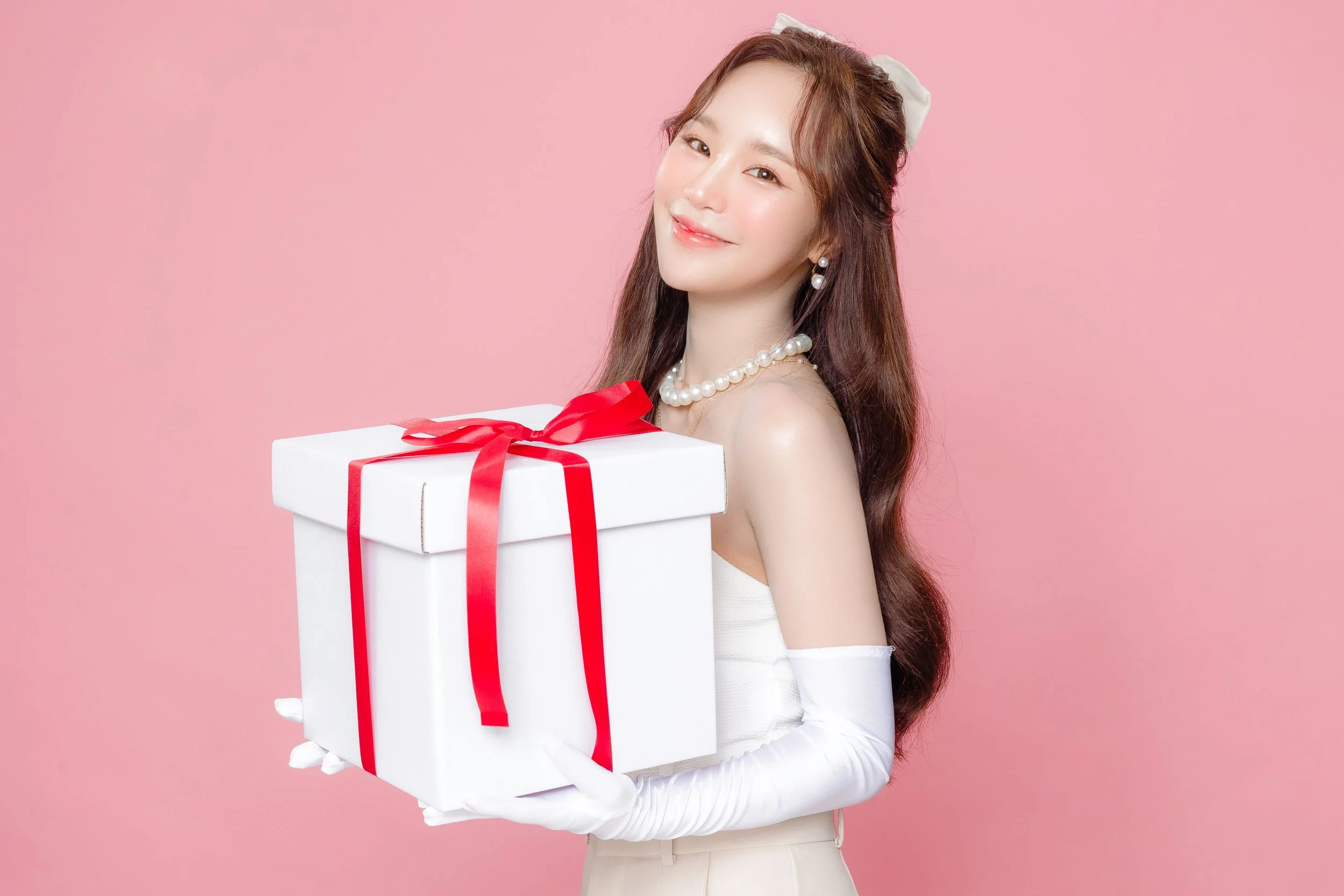 young-asian-beautiful-woman-curly-long-hair-with-korean-makeup-style-face-perfect-clear-smooth-skin-with-gift-box-isolated-pink-background-facial-treatment-cosmetology-plastic-surgery.jpg