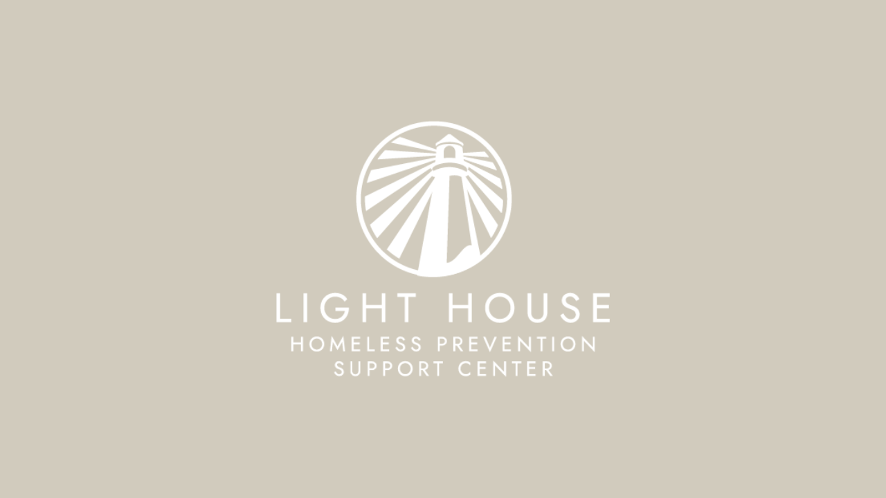 Logo of Light House Homeless Prevention Support Center featuring a lighthouse emitting rays of light.