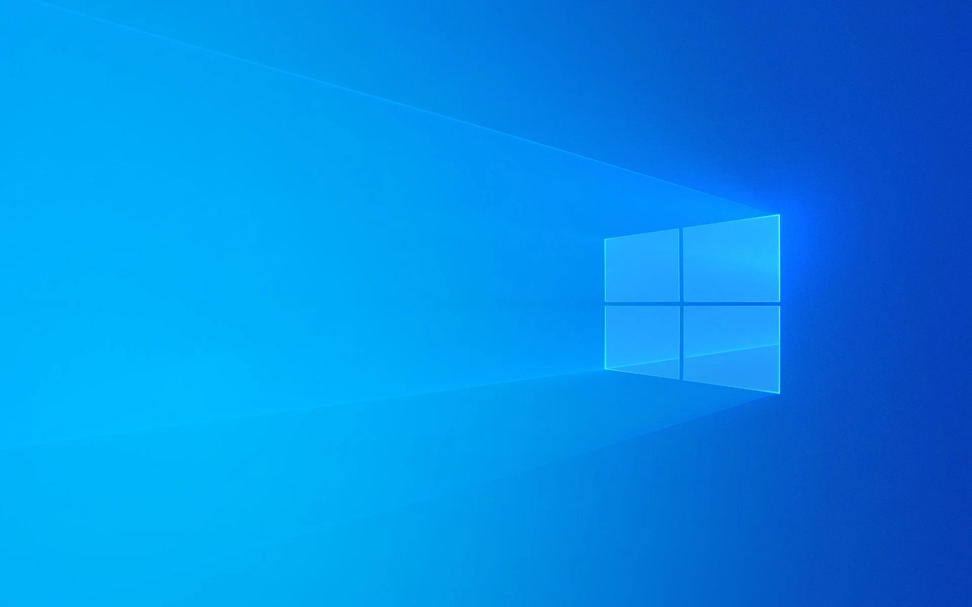 Desktop screen displaying the Windows 10 background with the Windows logo in the center, blue background, and light streaks.