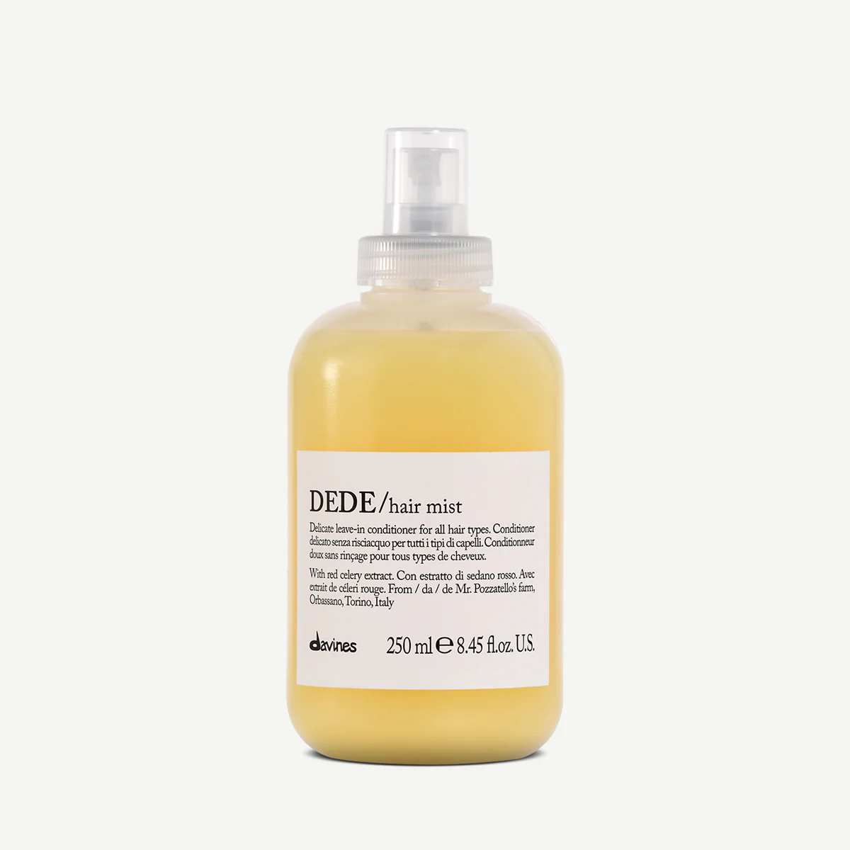 A yellow bottle of DEDE hair mist with a spray nozzle, labeled as a leave-in conditioner for all hair types with red celery extract, from Davines, 250 ml.