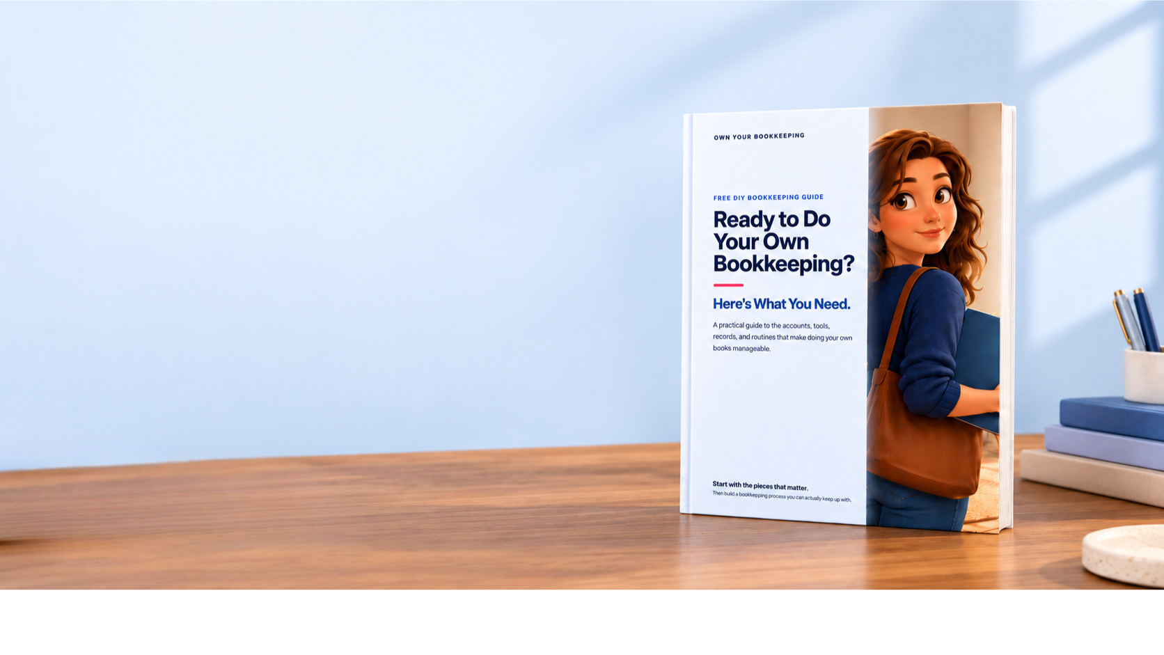 Hero image for Own Your Bookkeeping's free DIY bookkeeping guide, featuring the guide cover titled "Ready to Do Your Own Bookkeeping? Here's What You Need" standing on a desk on the right, with warm neutral workspace styling