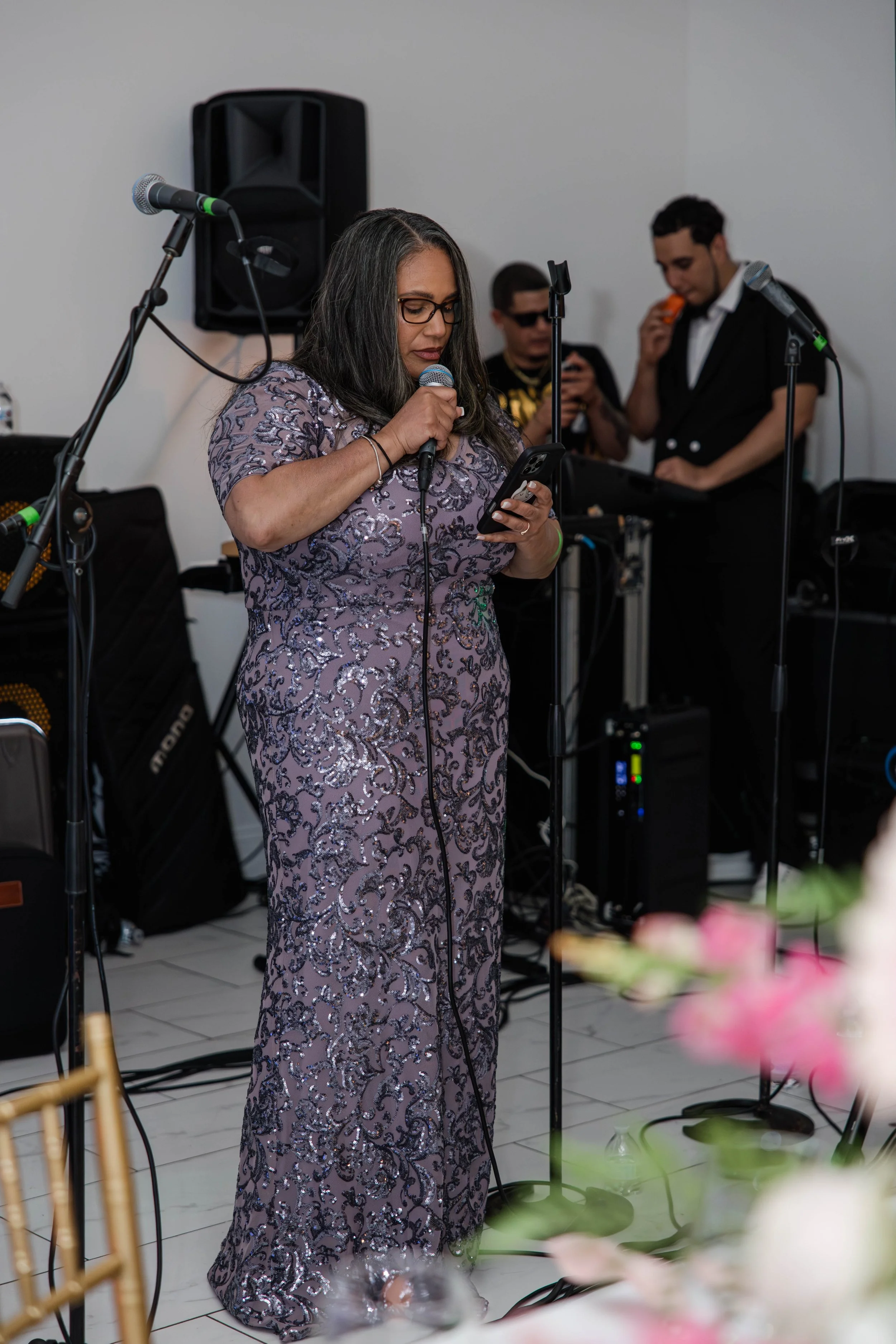 Mother giving an emotional speech at a Long Island graduation party with live music in the background by Moon & Stars Photography.