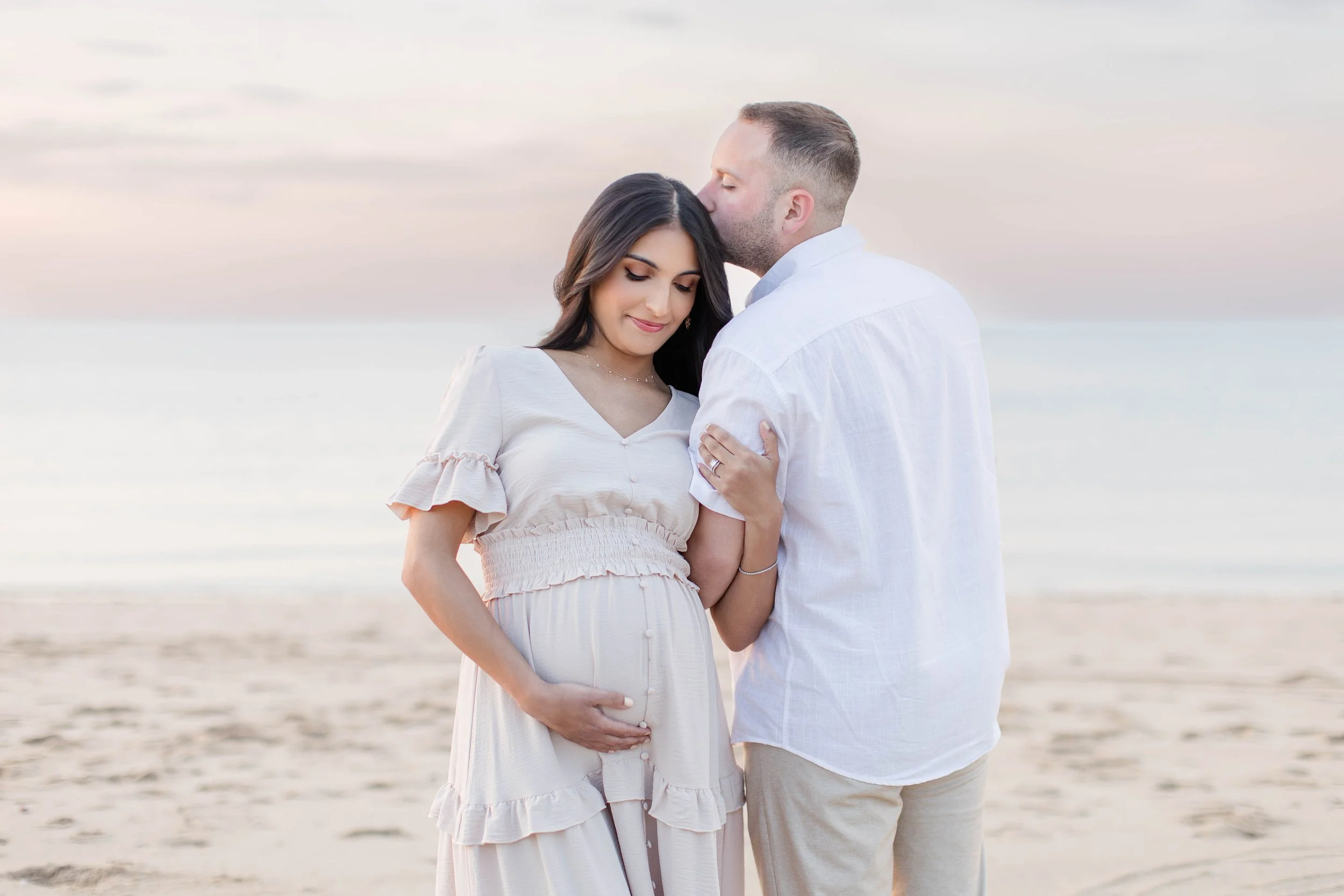 Pregnant mother and family during a sunset maternity session at Sunken Meadow State Park on Long Island, captured by a Long Island maternity photographer.