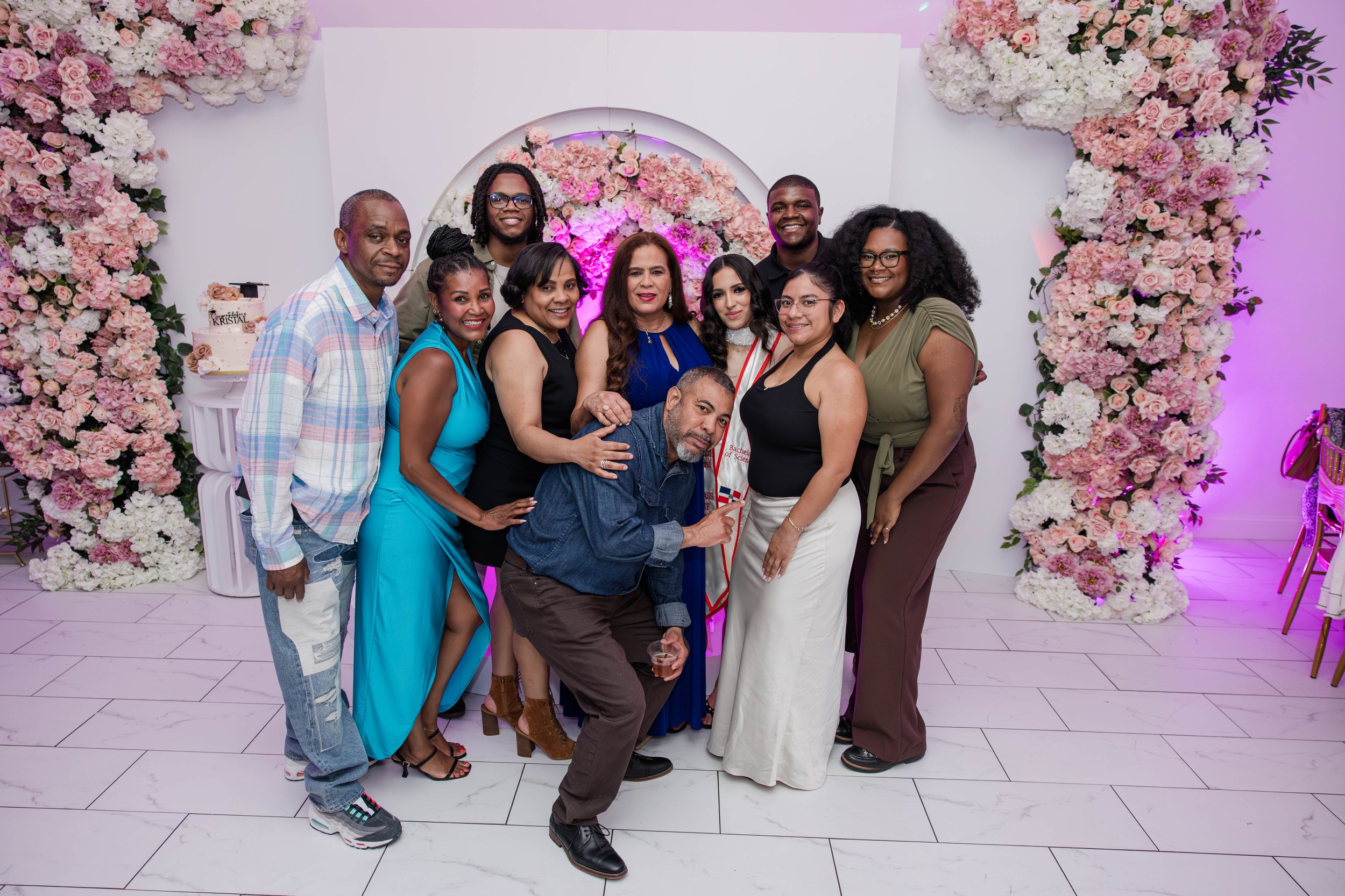 Large family portrait celebrating a college graduation at a beautifully decorated Margarets Venue in Freeport NY event venue by Moon & Stars Photography.