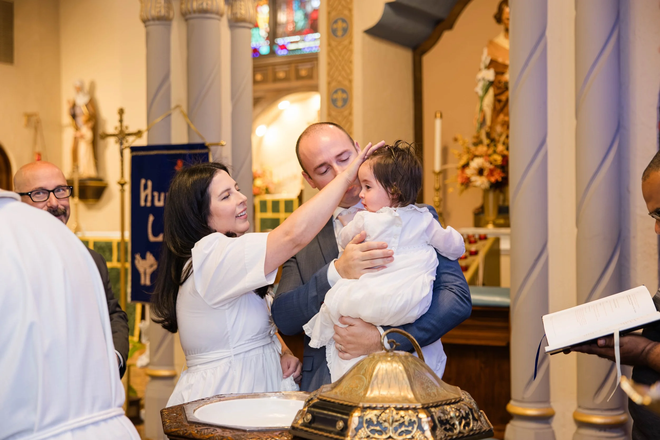 family-baptism-moment-our-lady-of-lourdes-church-nassau-county-ny