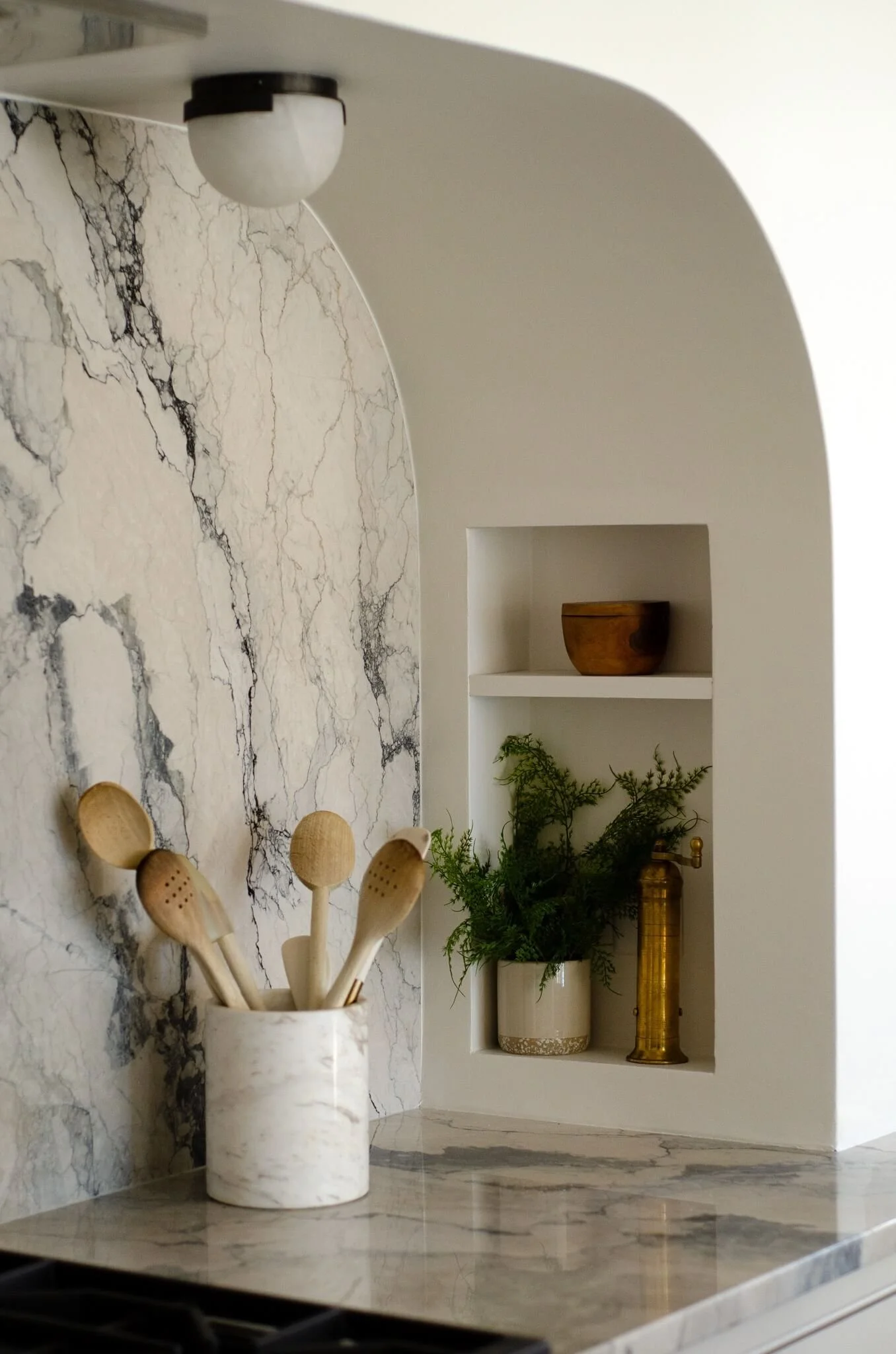 A built-in niche beside the range - a small architectural moment for the everyday things.