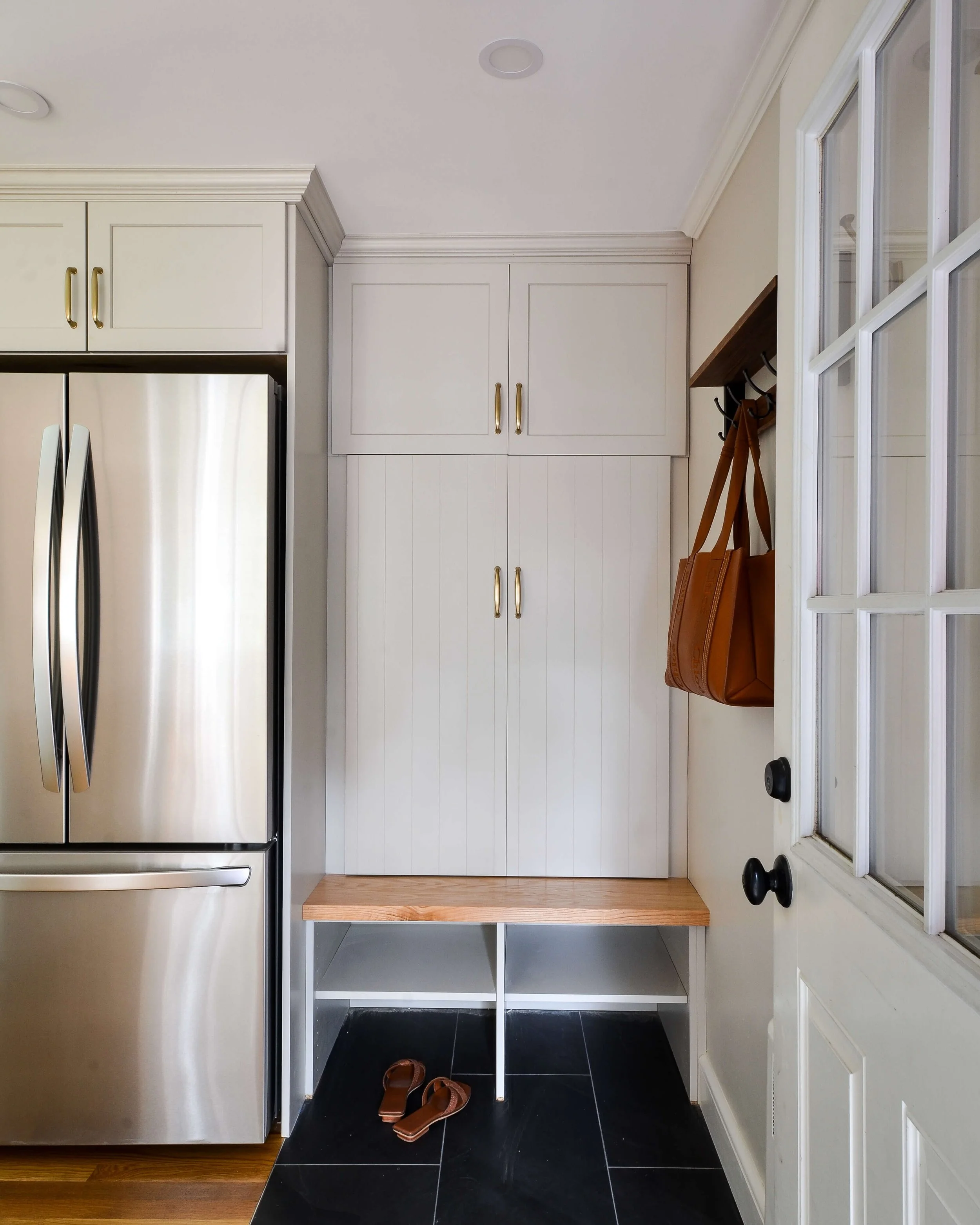 Small space, distinct identity. A simple flooring transition turns this mudroom into a room of its own, right off the kitchen.