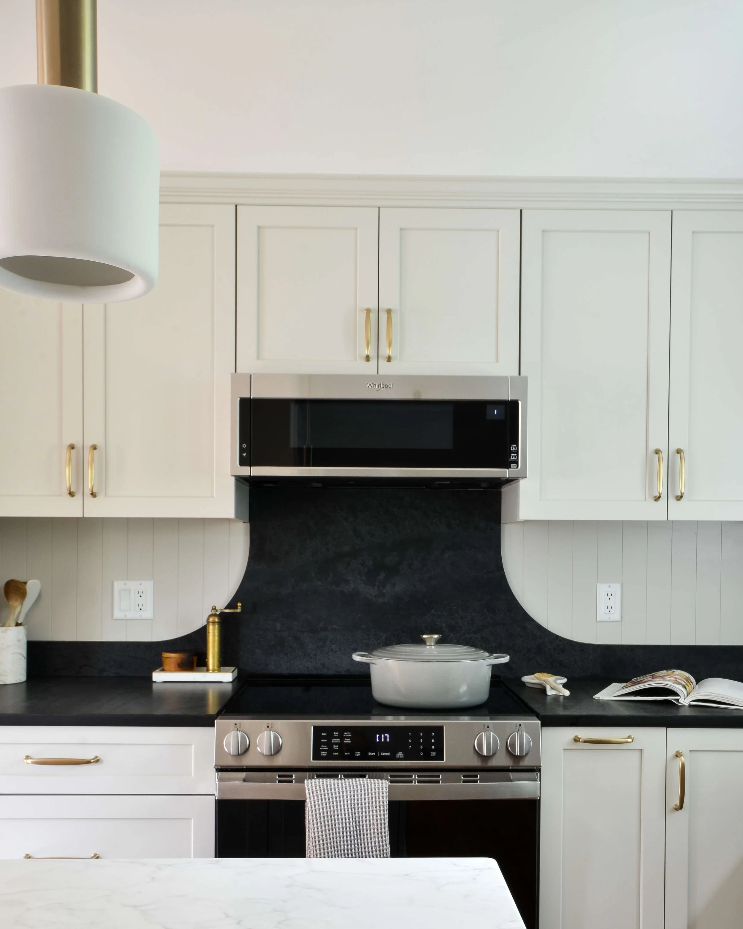A radius natural stone backsplash meets vertical shiplap lines - different textures, one harmonious intersection.