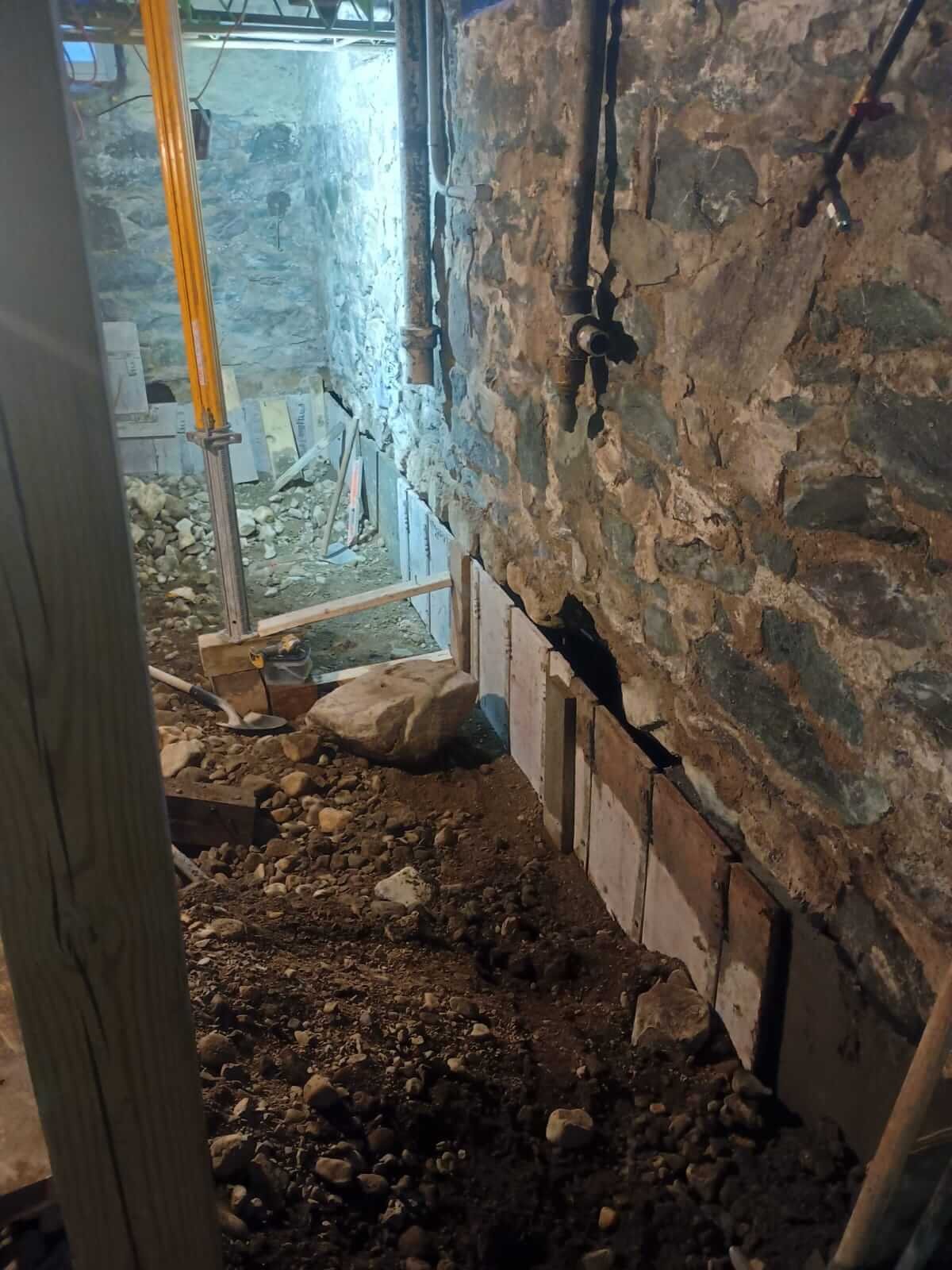 Dug out, braced, and formed. Ready for concrete beneath the original stone.