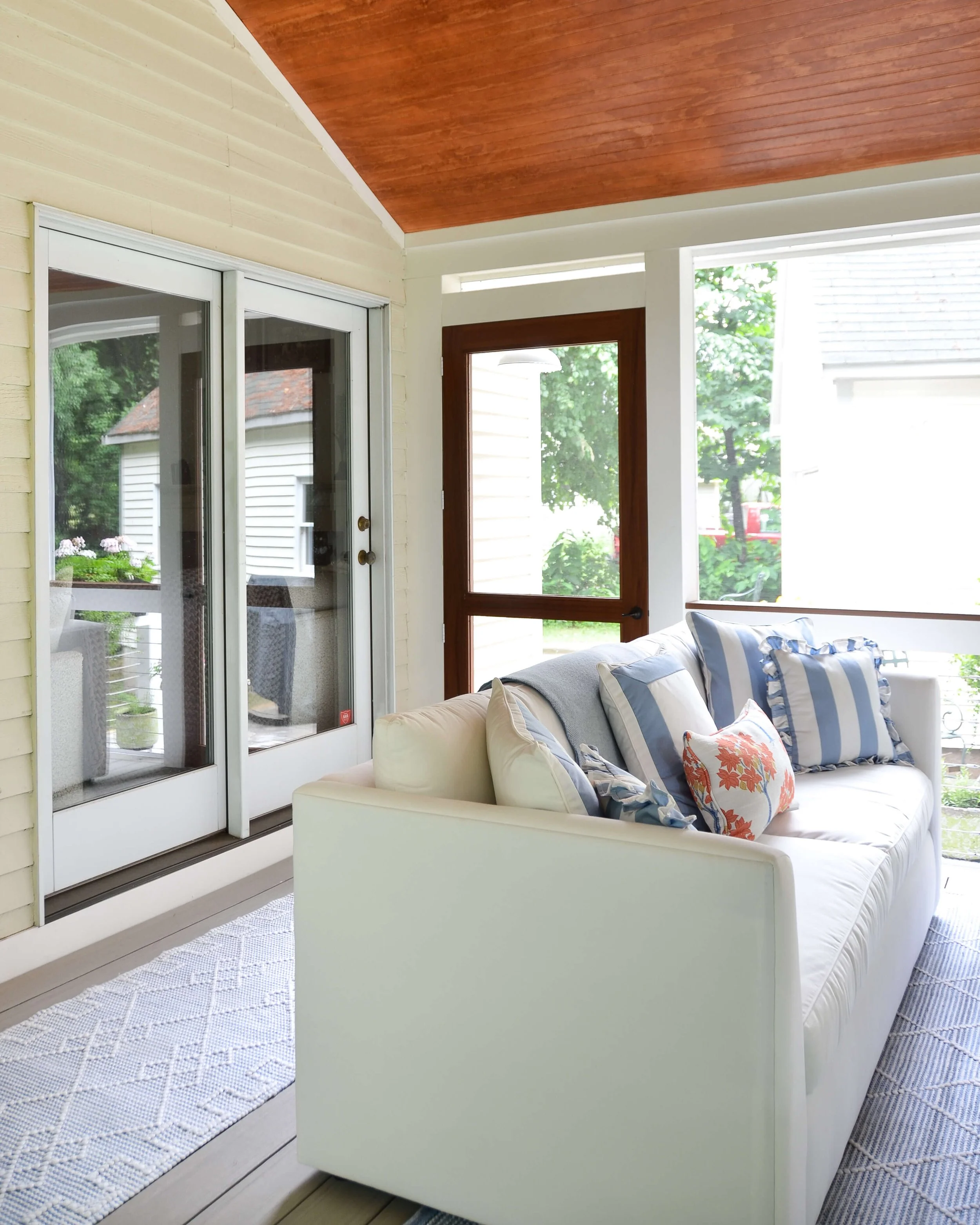 French doors on one side, the screen door on the other. The porch connects straight to the house.