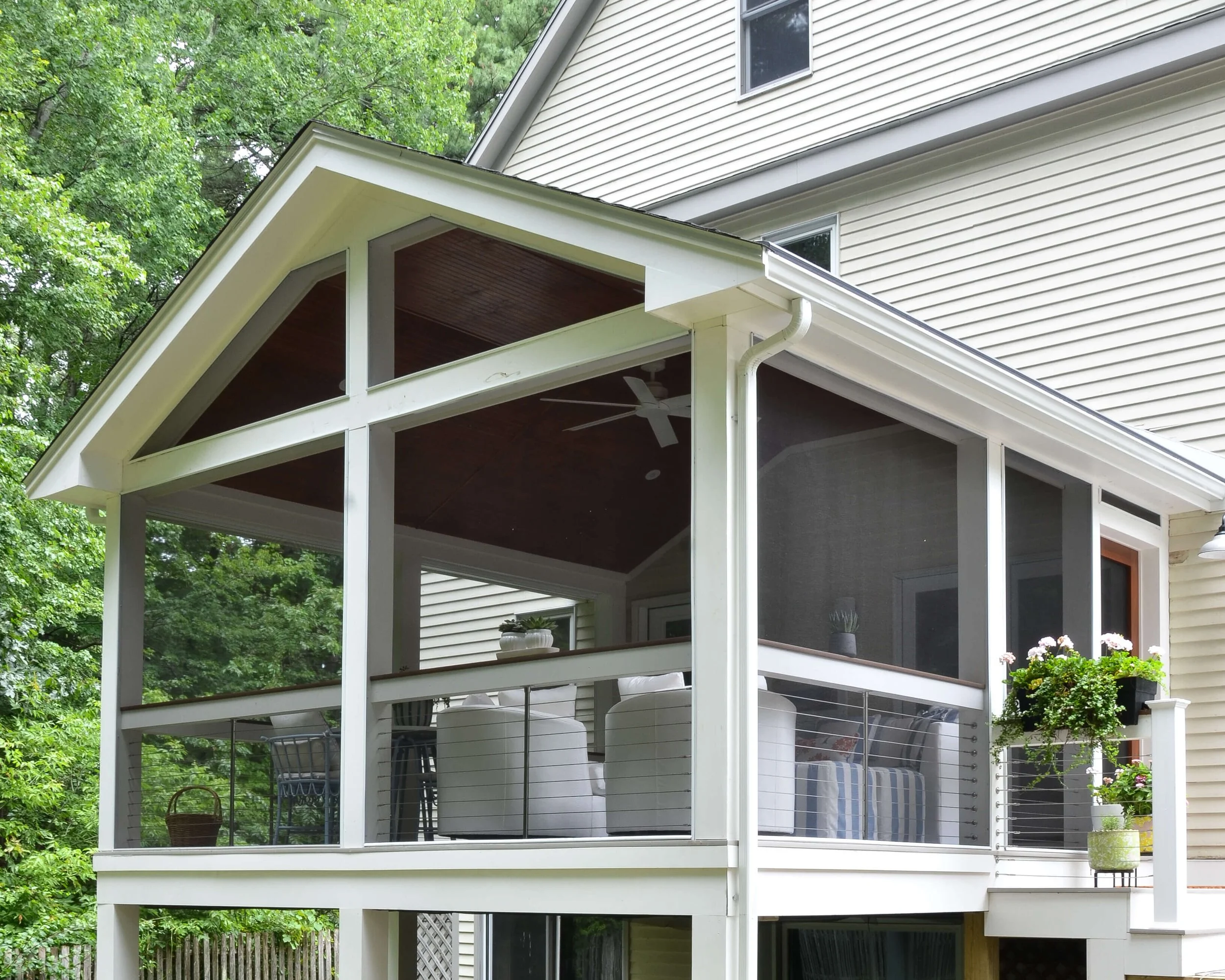 A gabled screened porch, built to look like it was always part of the house.