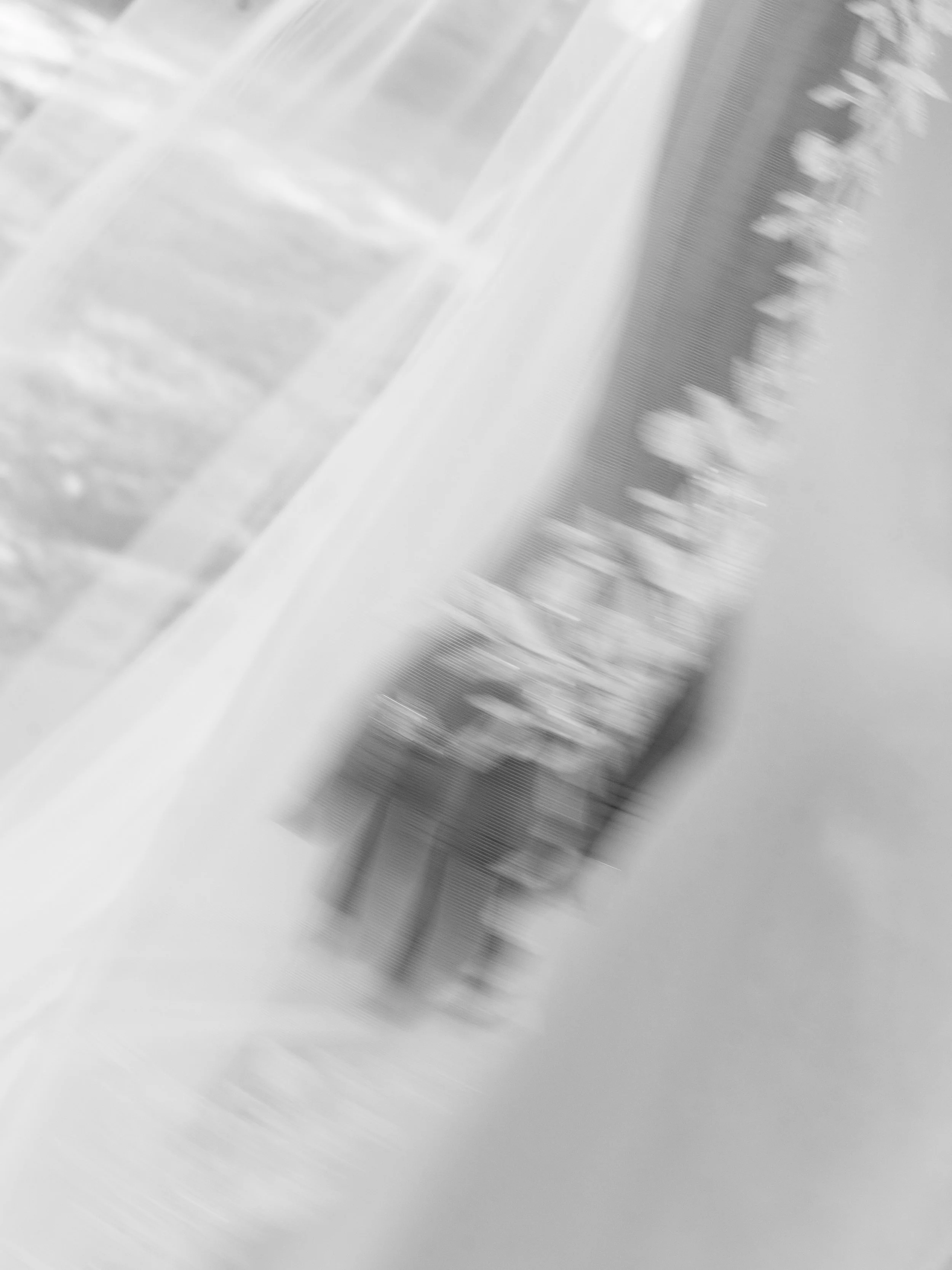 Blurred image of a bookshelf with books in black and white.