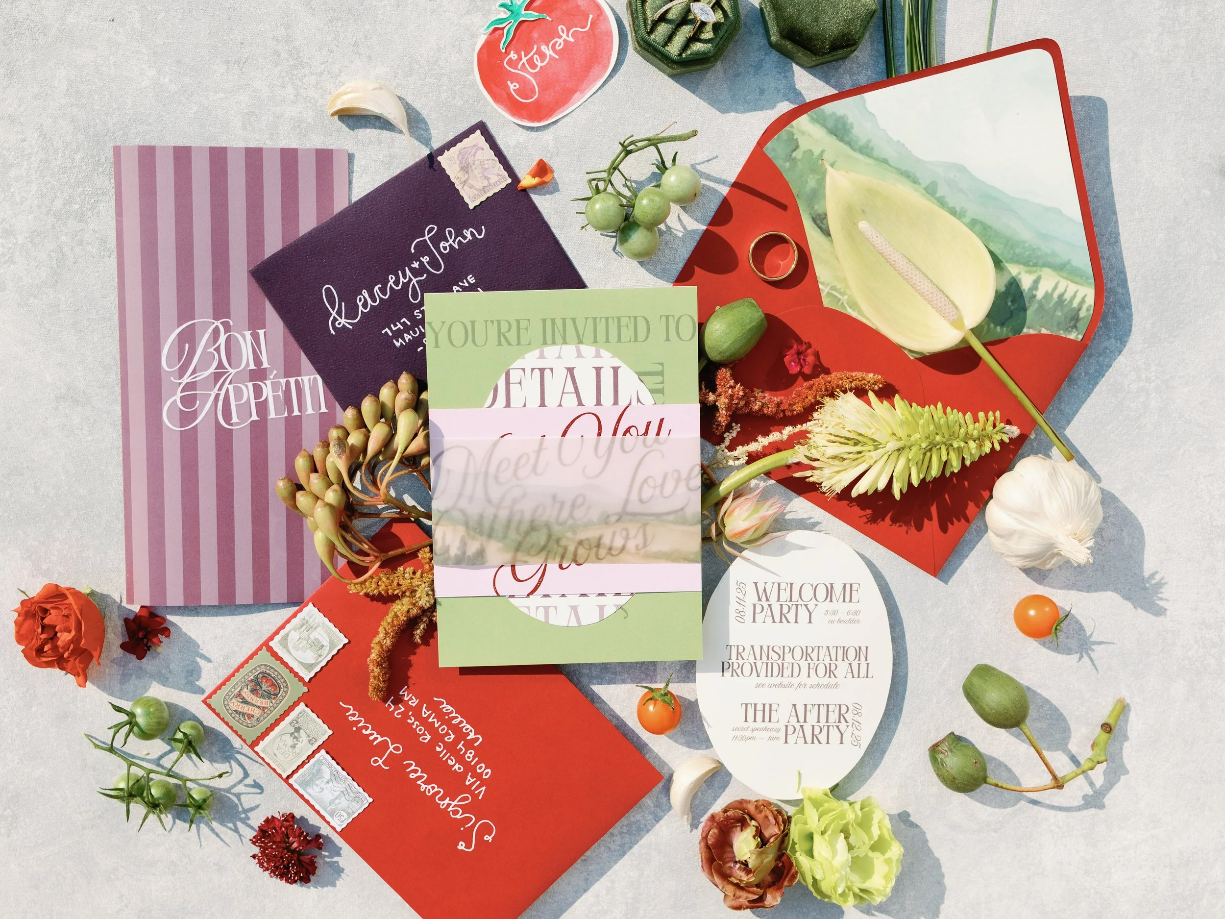 Collection of wedding invitation cards, flowers, and decorations on a light surface.