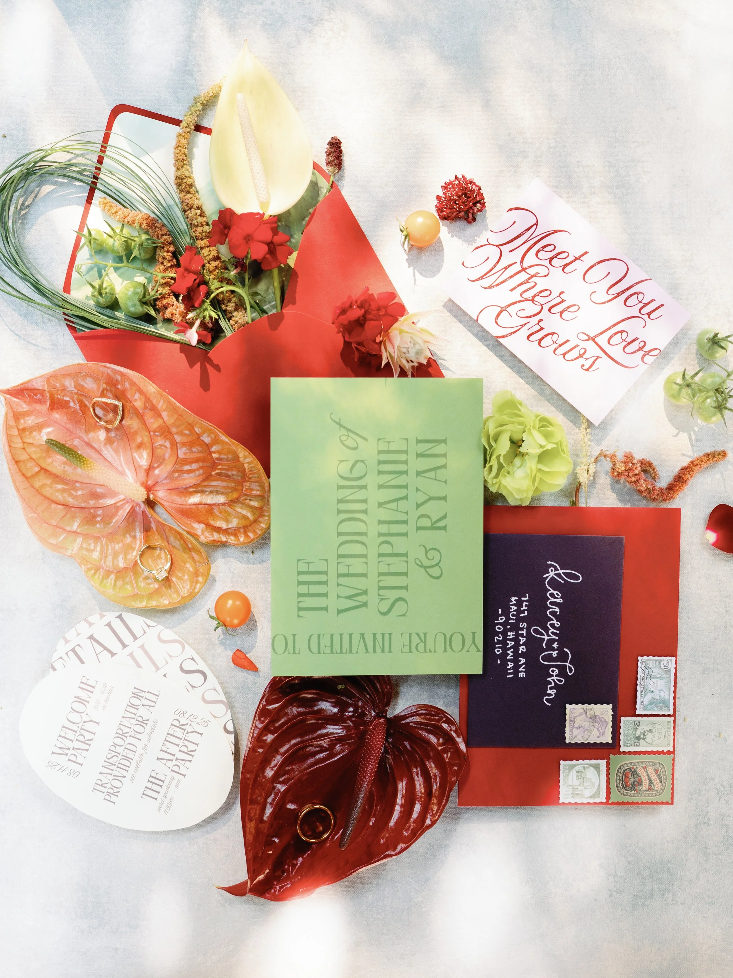 Wedding invitation surrounded by flowers, leaves, and decorative paper, with a message that says "Meet You Where Love Grows."