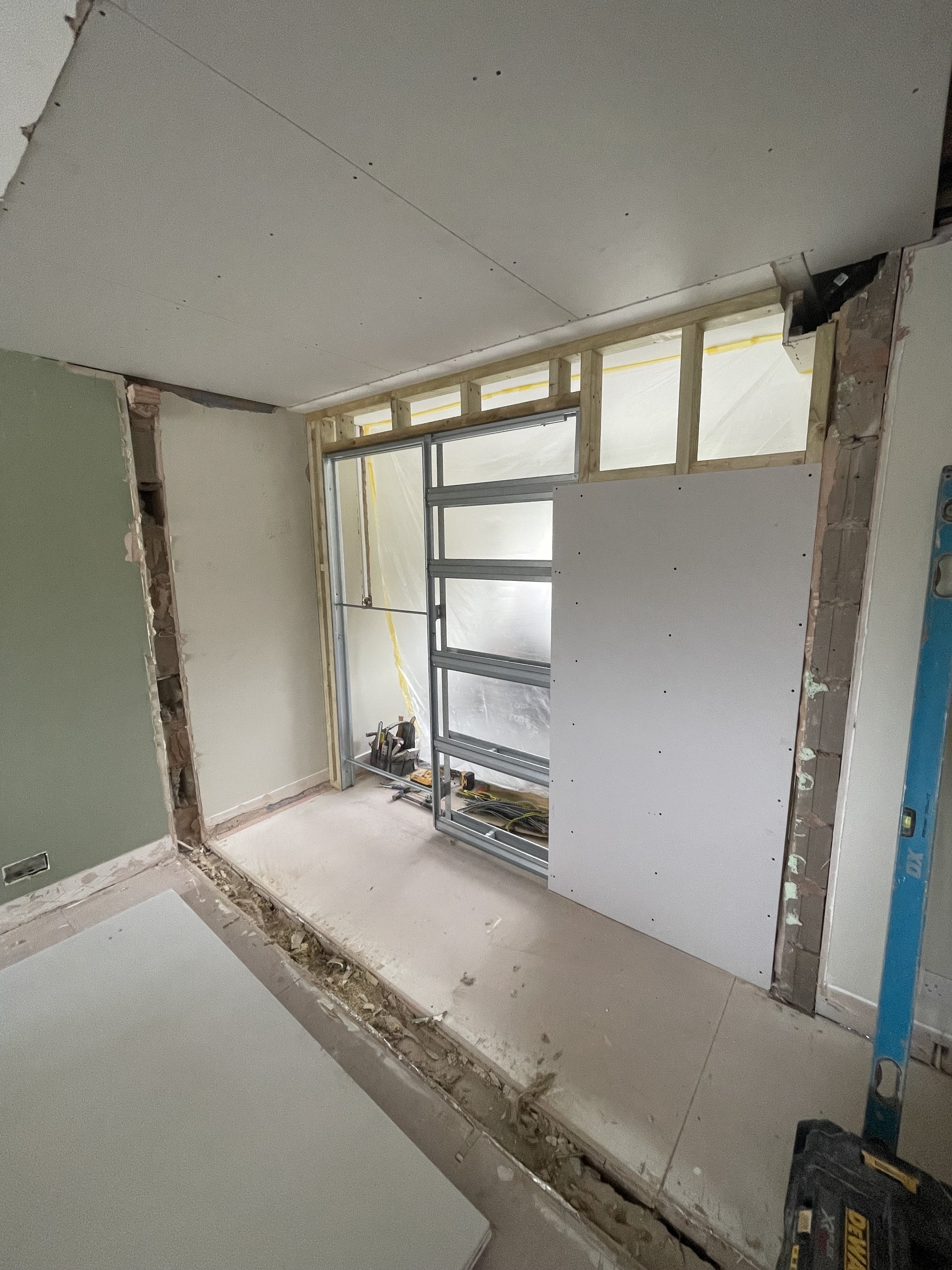 Internal alteration in progress with new metal pocket door frame and repositioned stud wall