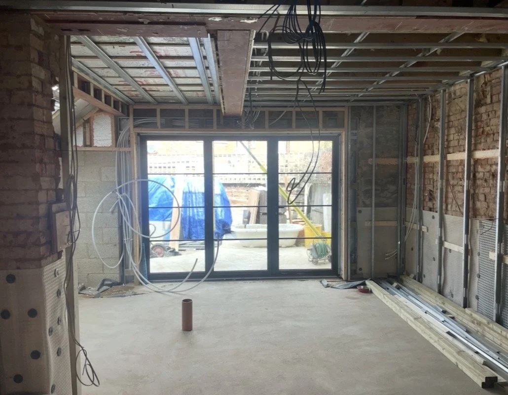 Major structural alterations to a West London home with new steelwork, metal framing and openings forming a reconfigured open-plan layout