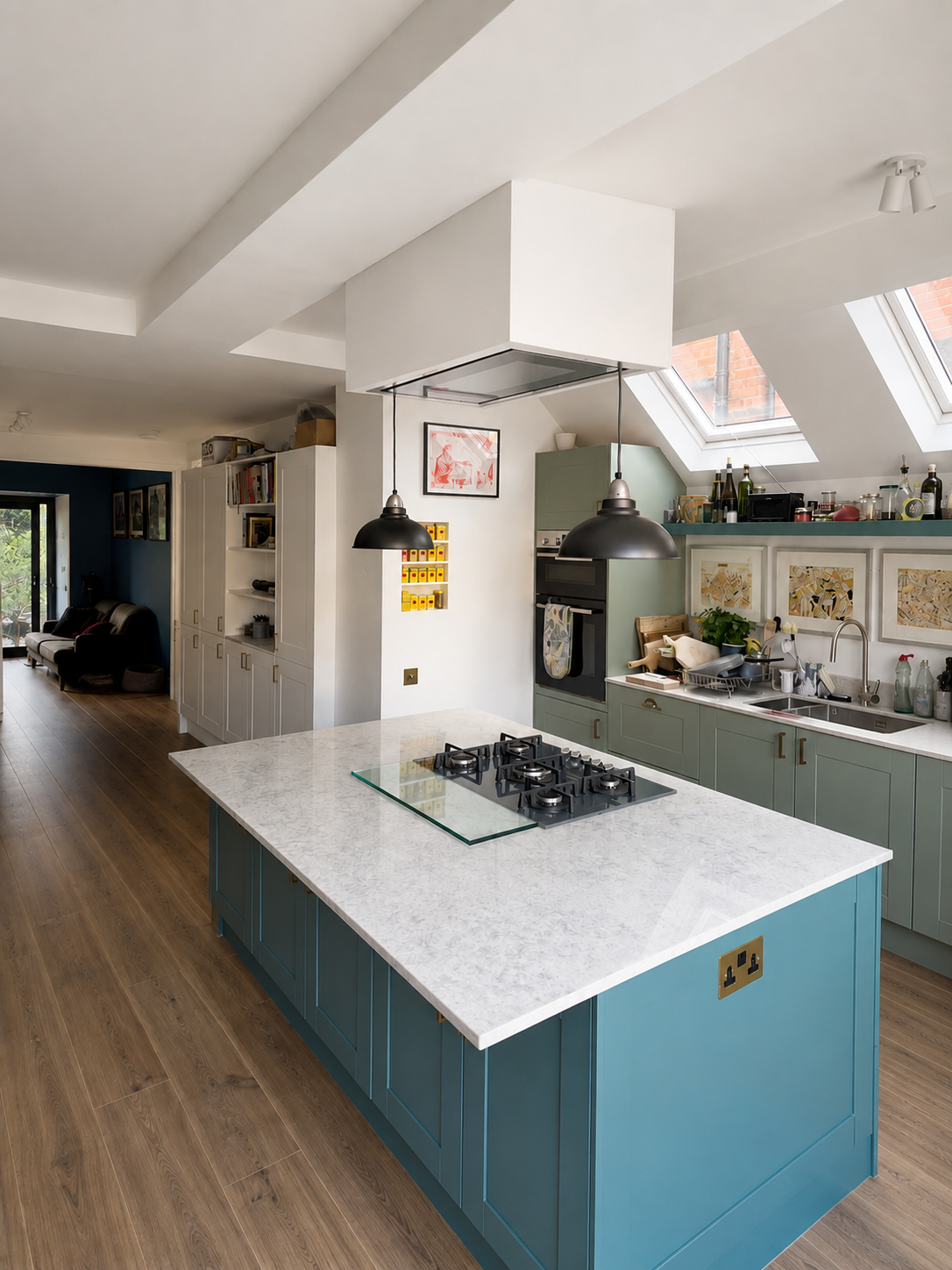 Bespoke kitchen extension with hand-painted cabinetry, stone worktops, island gas hob, built-in extractor, spice niche and Velux roof windows