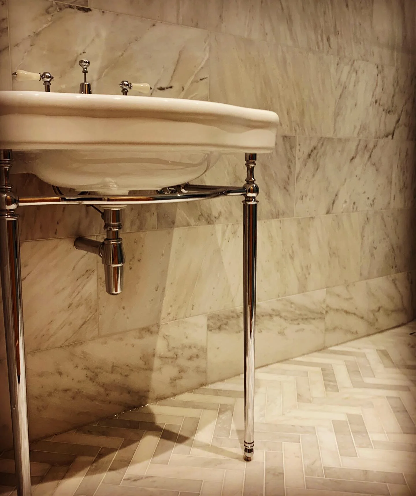Natural marble bathroom renovation with bespoke tiling and luxury finishes