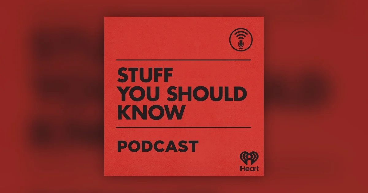 A red square podcast cover with the title "Stuff You Should Know Podcast" in large black letters, a microphone icon at the top right, and the iHeartRadio logo at the bottom right.
