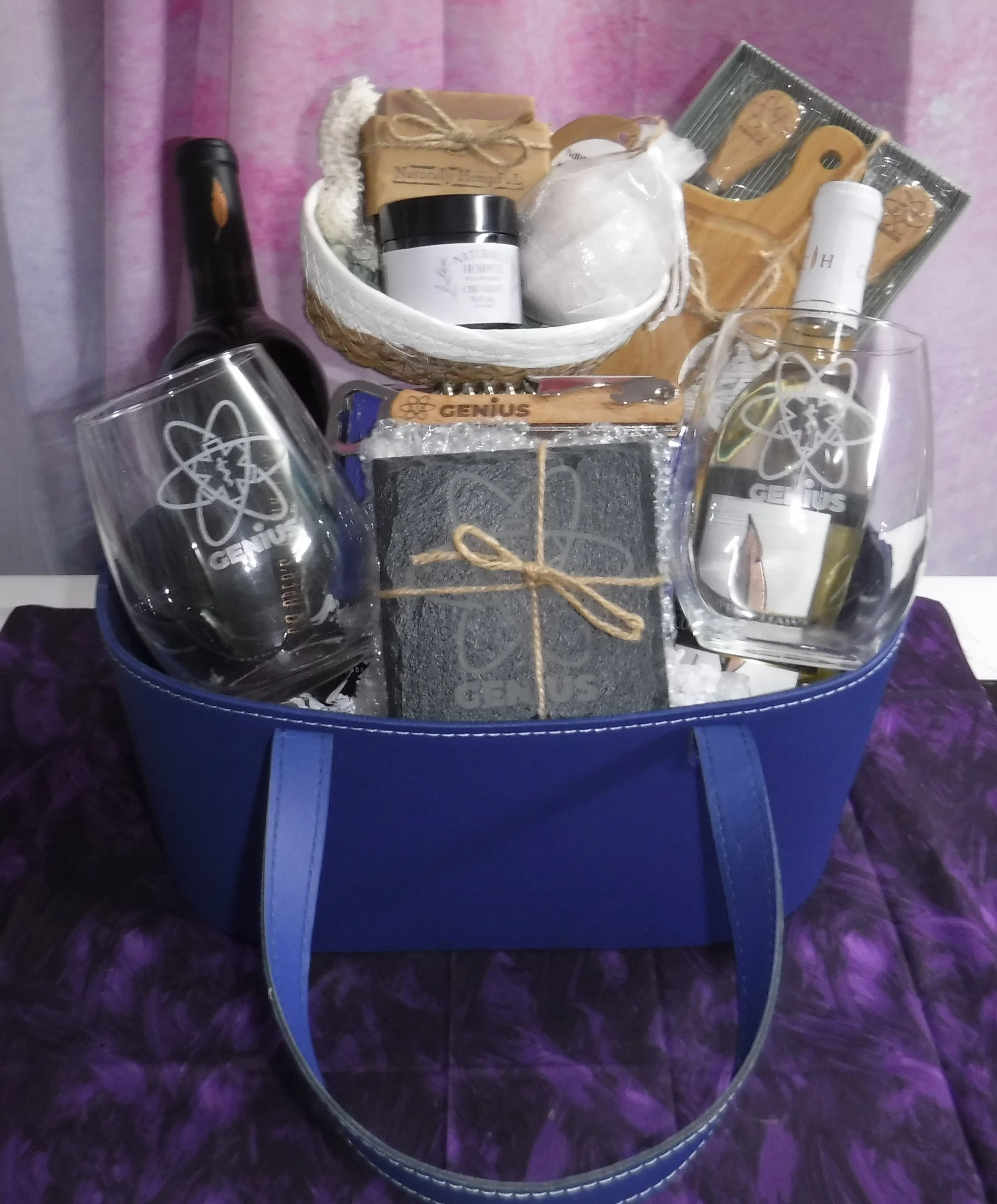 A gift basket going out to a client filled with multiple engraved items by Second Alarm Creations