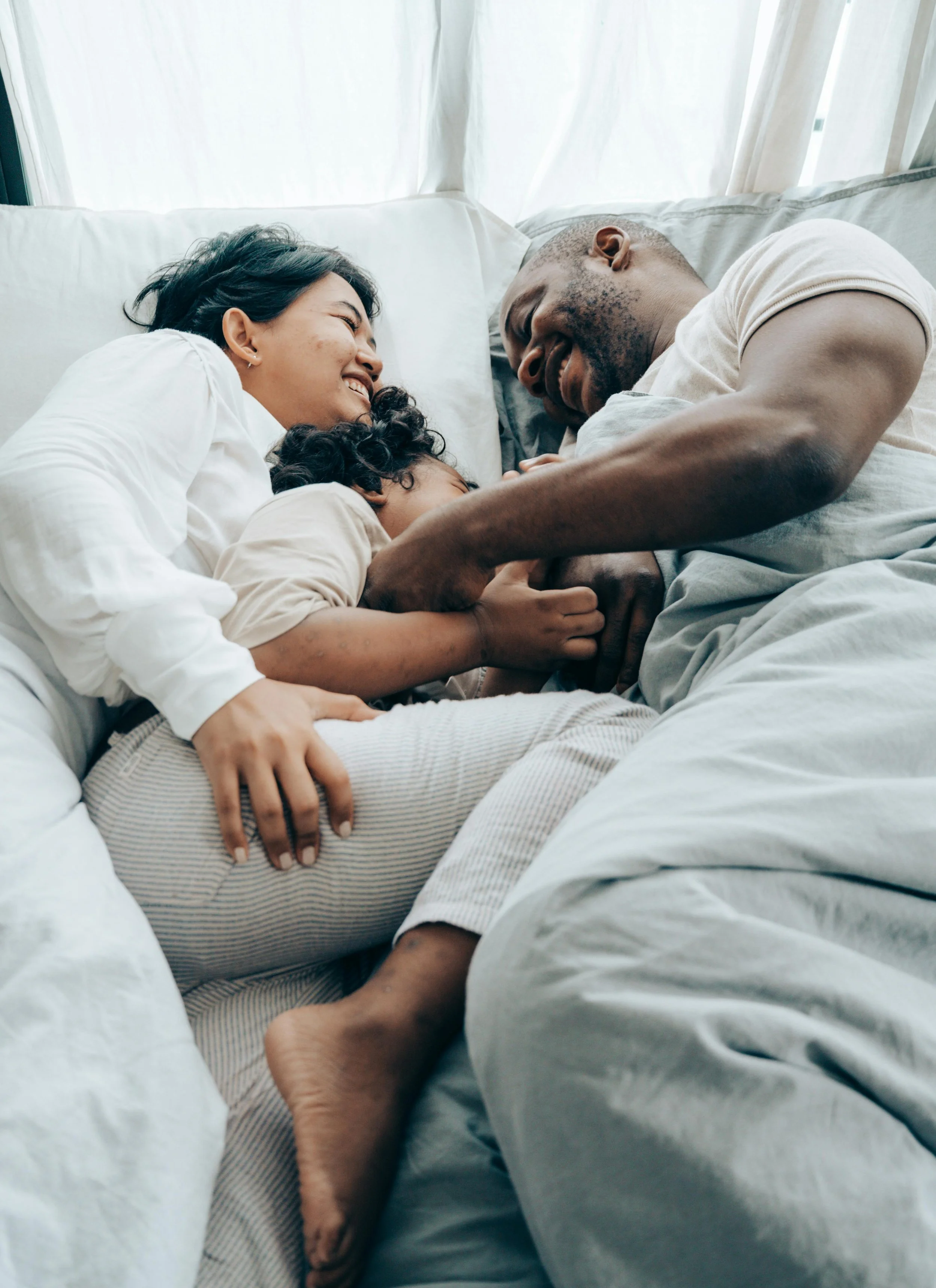 woman, man child laughing on bed together peace after past emotionally immature relationships