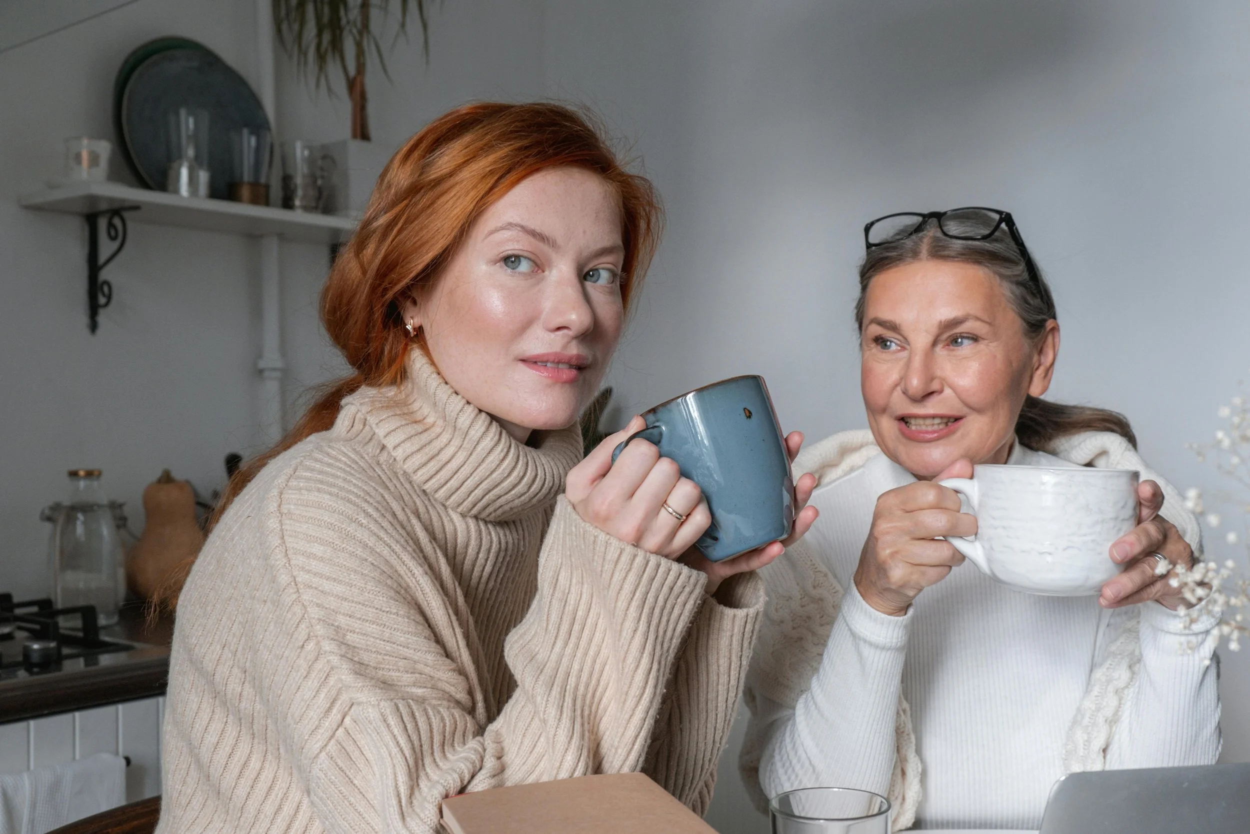 Adult woman and mother with coffee at kitchen table