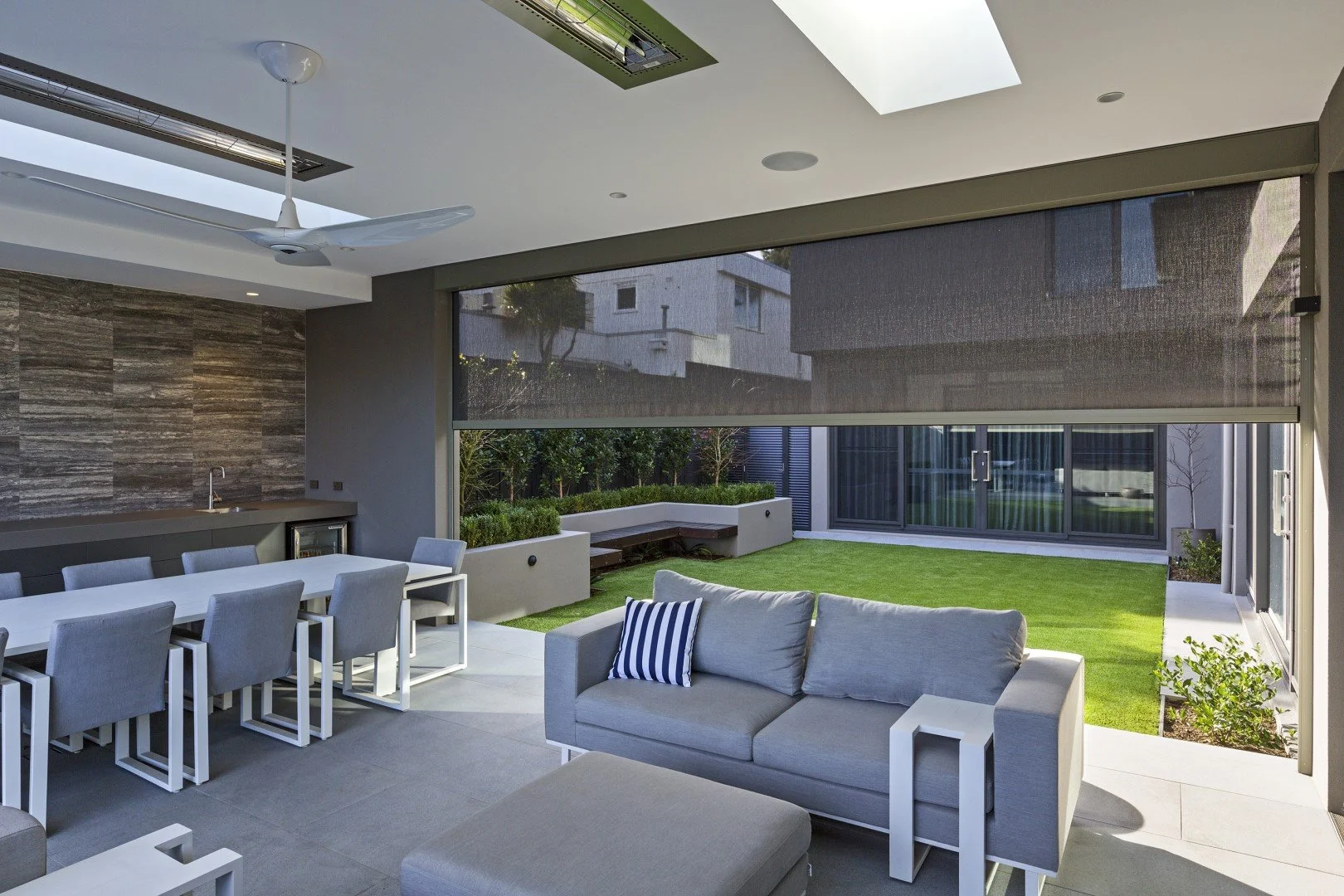 Modern outdoor patio with custom motorized solar shades by Smart Shade Studio, featuring Clara Shades outdoor shade systems for sun control, privacy, and seamless indoor outdoor living.