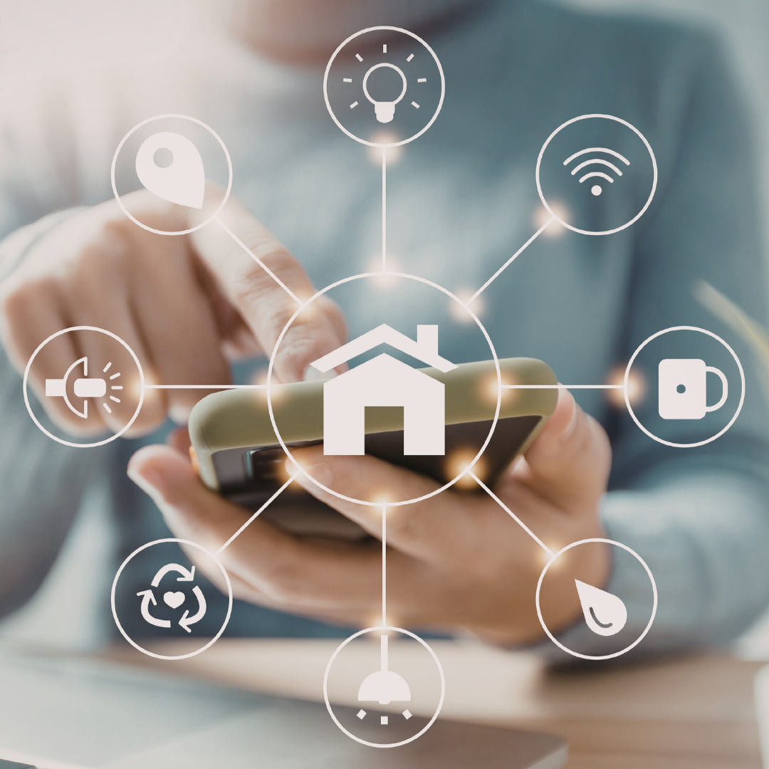 Person using a smartphone with smart home icons overlayed, including a house, light bulb, Wi-Fi, camera, thermostat, and recycling symbol.
