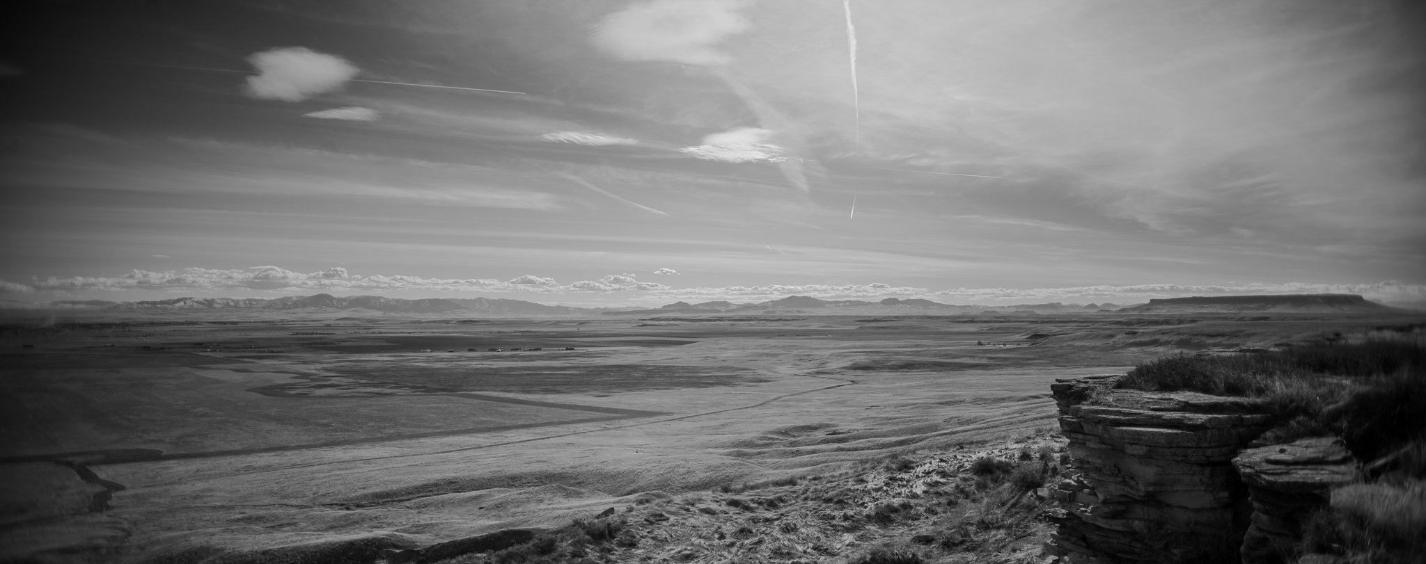 Black and white photo of cliff and mountains