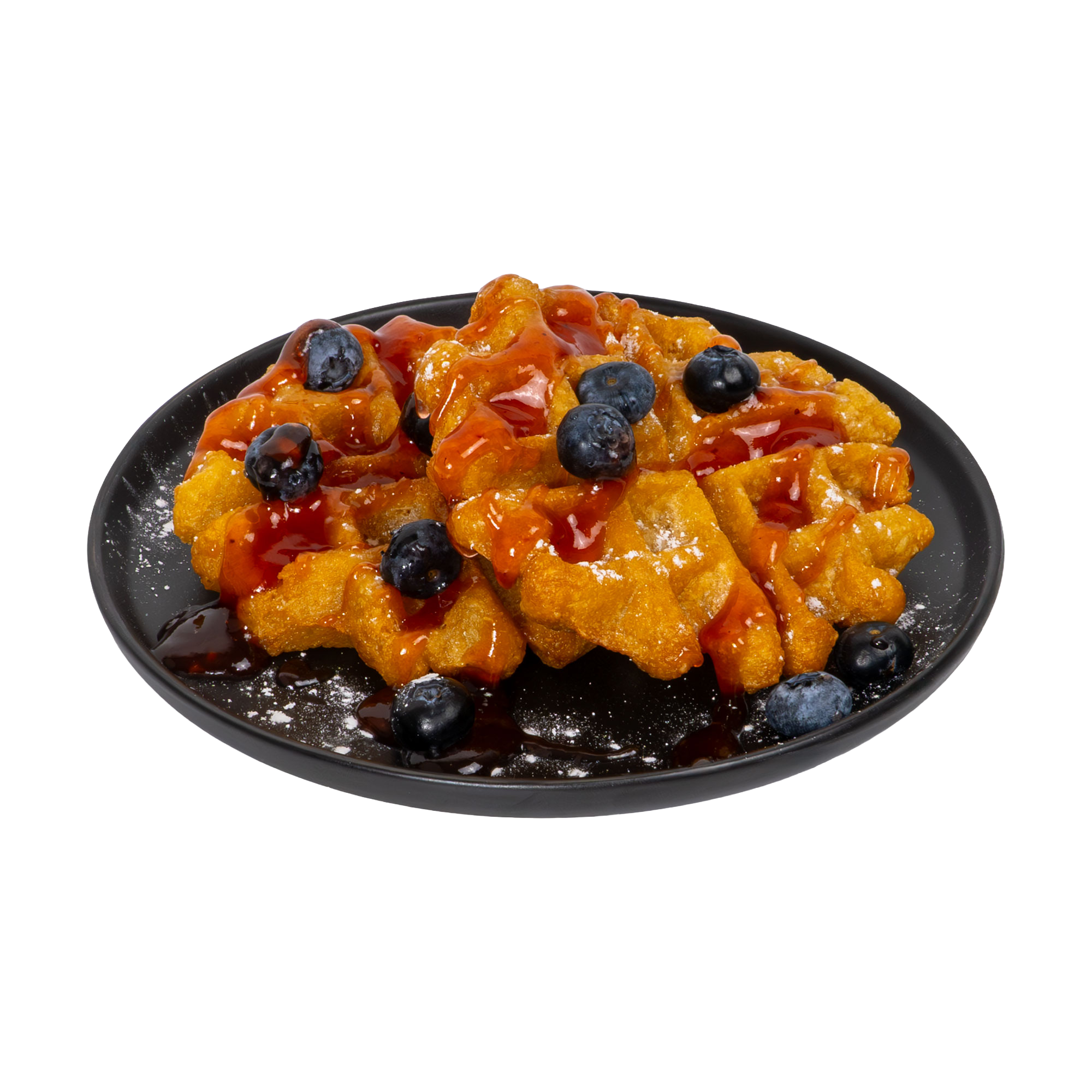 Cassava waffles with blueberry sauce on a black plate