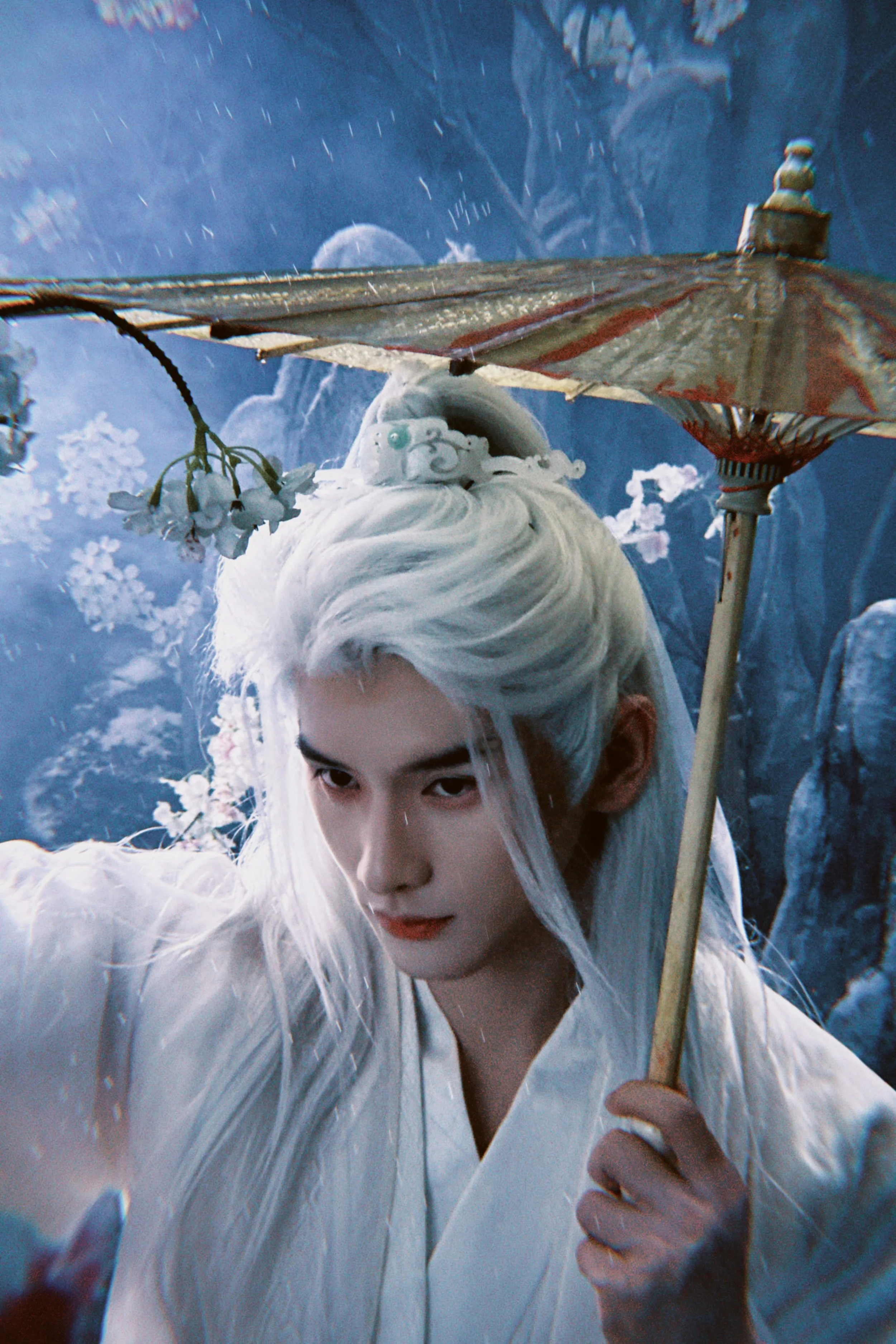 A person with long white hair holding a traditional paper umbrella with a flower, in a fantasy setting with snow and moonlit background.
