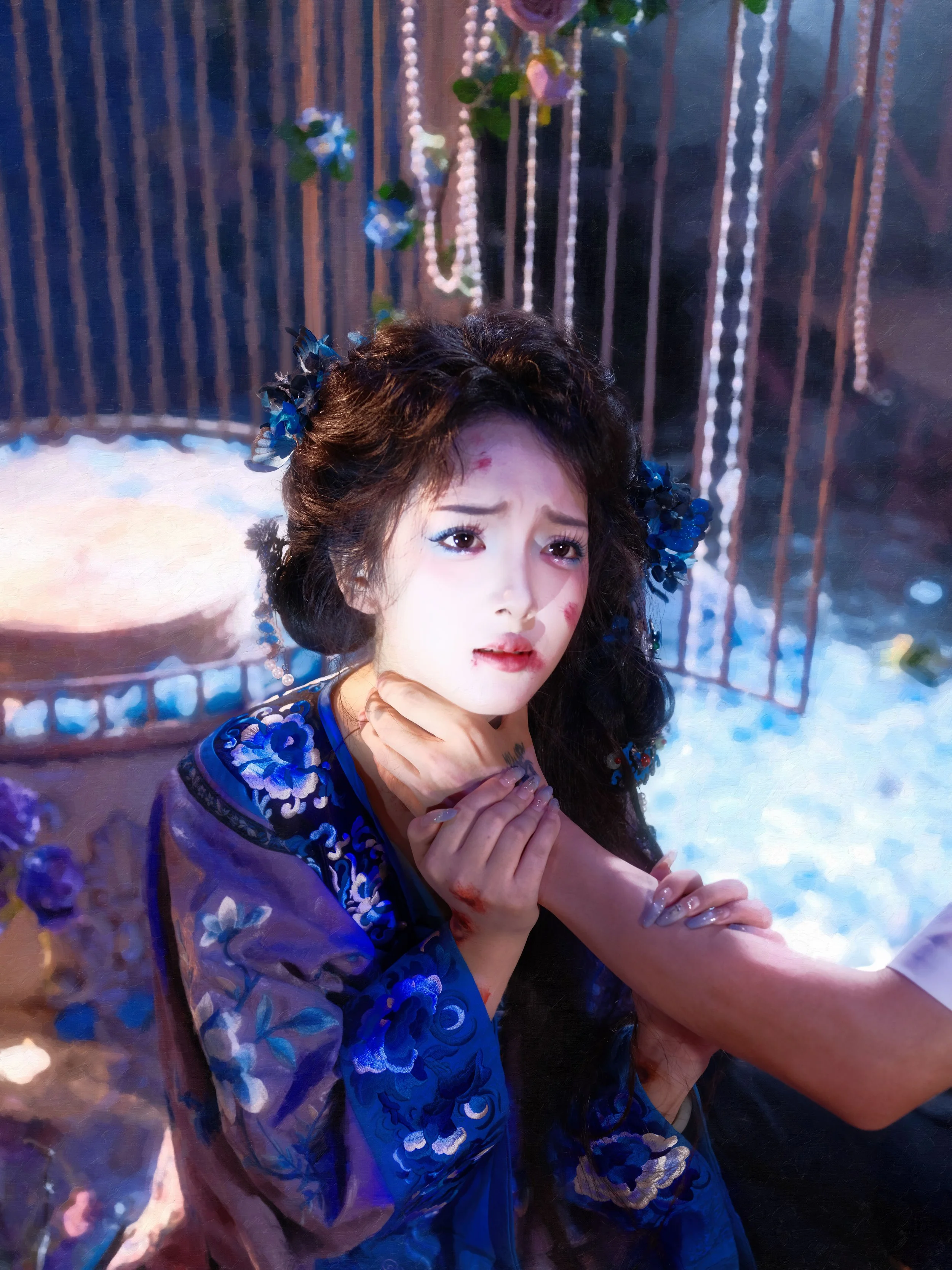 A distressed woman in traditional attire with floral hair accessories, clutching her neck and arm, surrounded by a cage and hanging beads, with a snowy ground and flowers in the background.