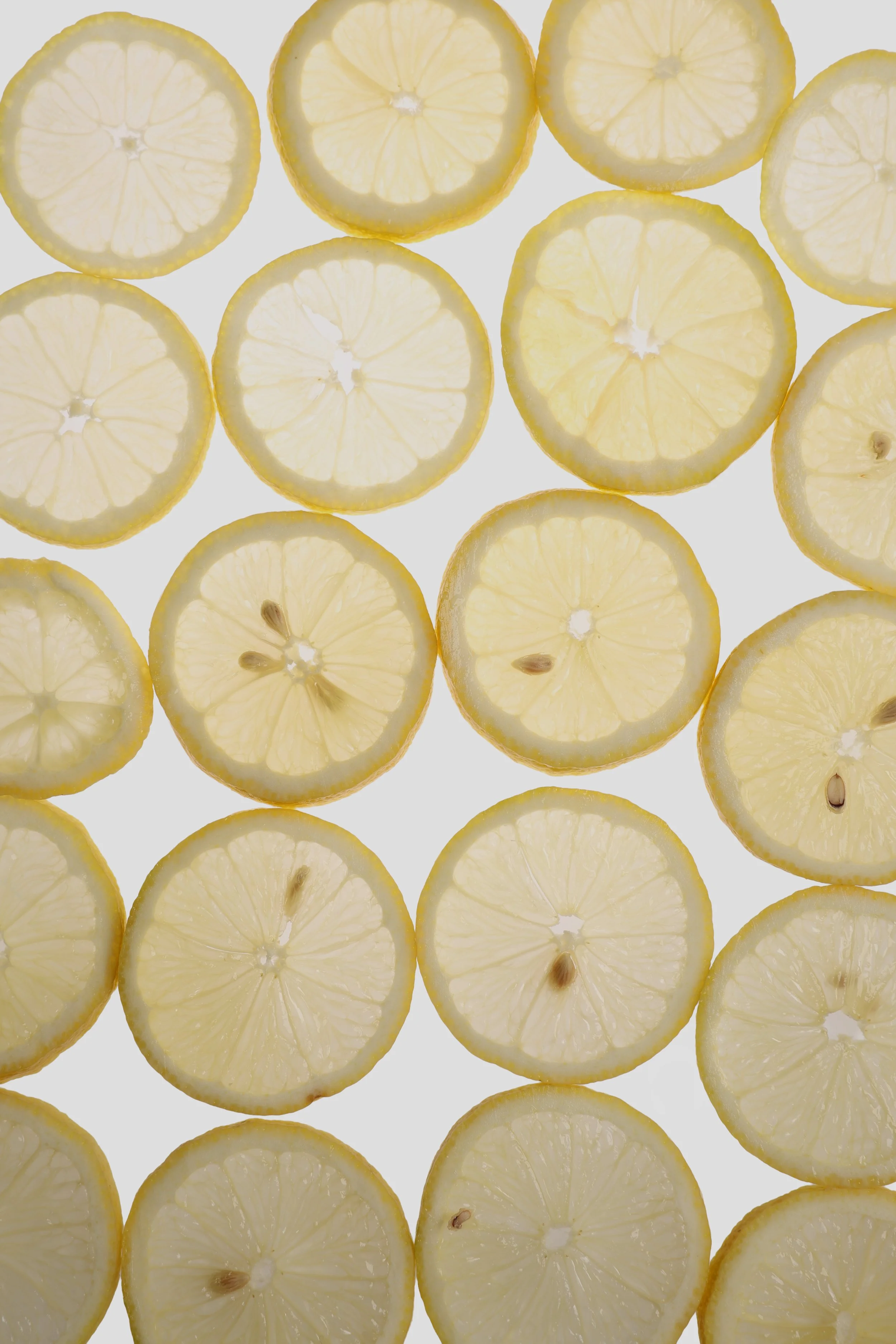 Slices of lemon arranged on a white background.