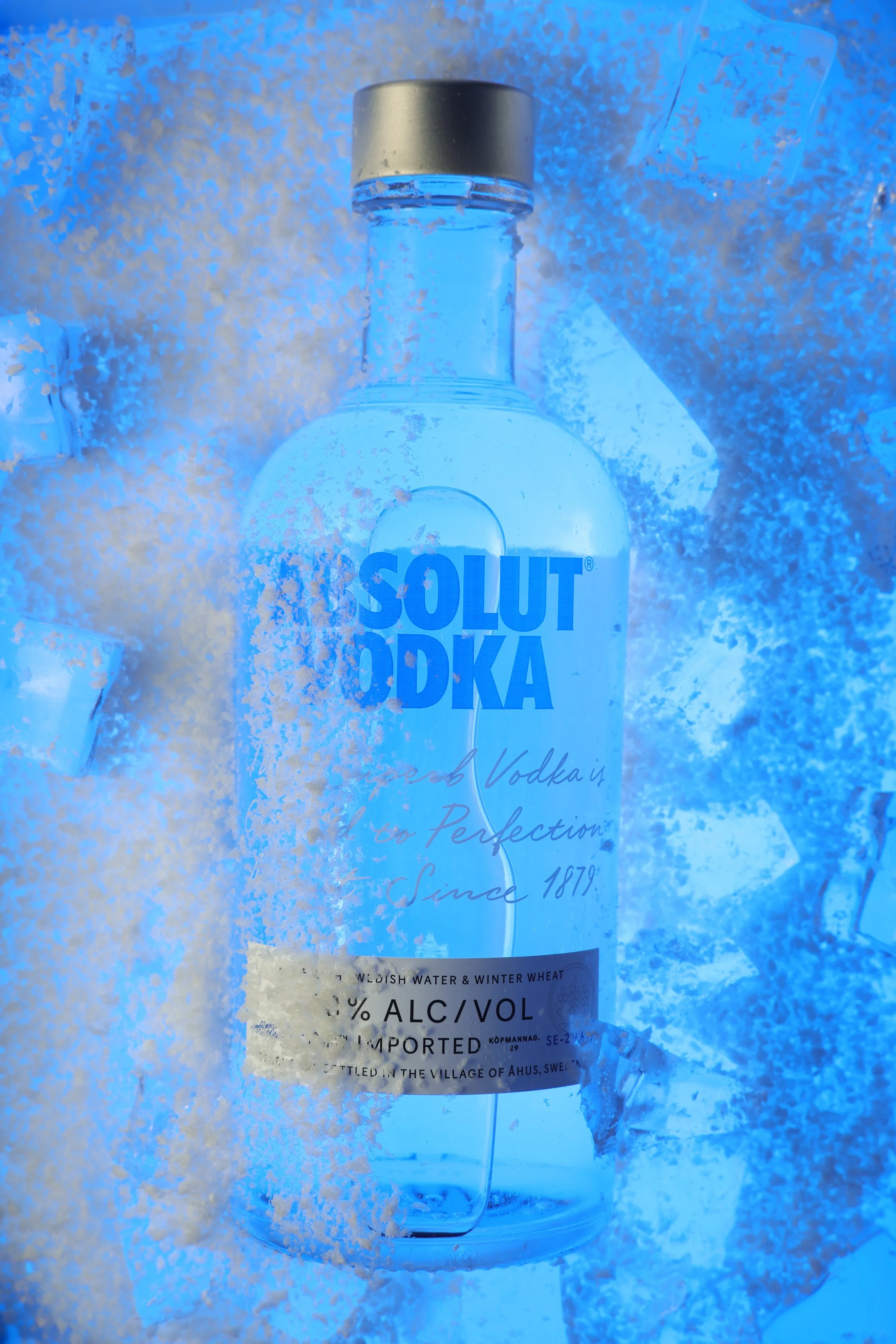 A bottle of Absolut Vodka surrounded by snow and ice.