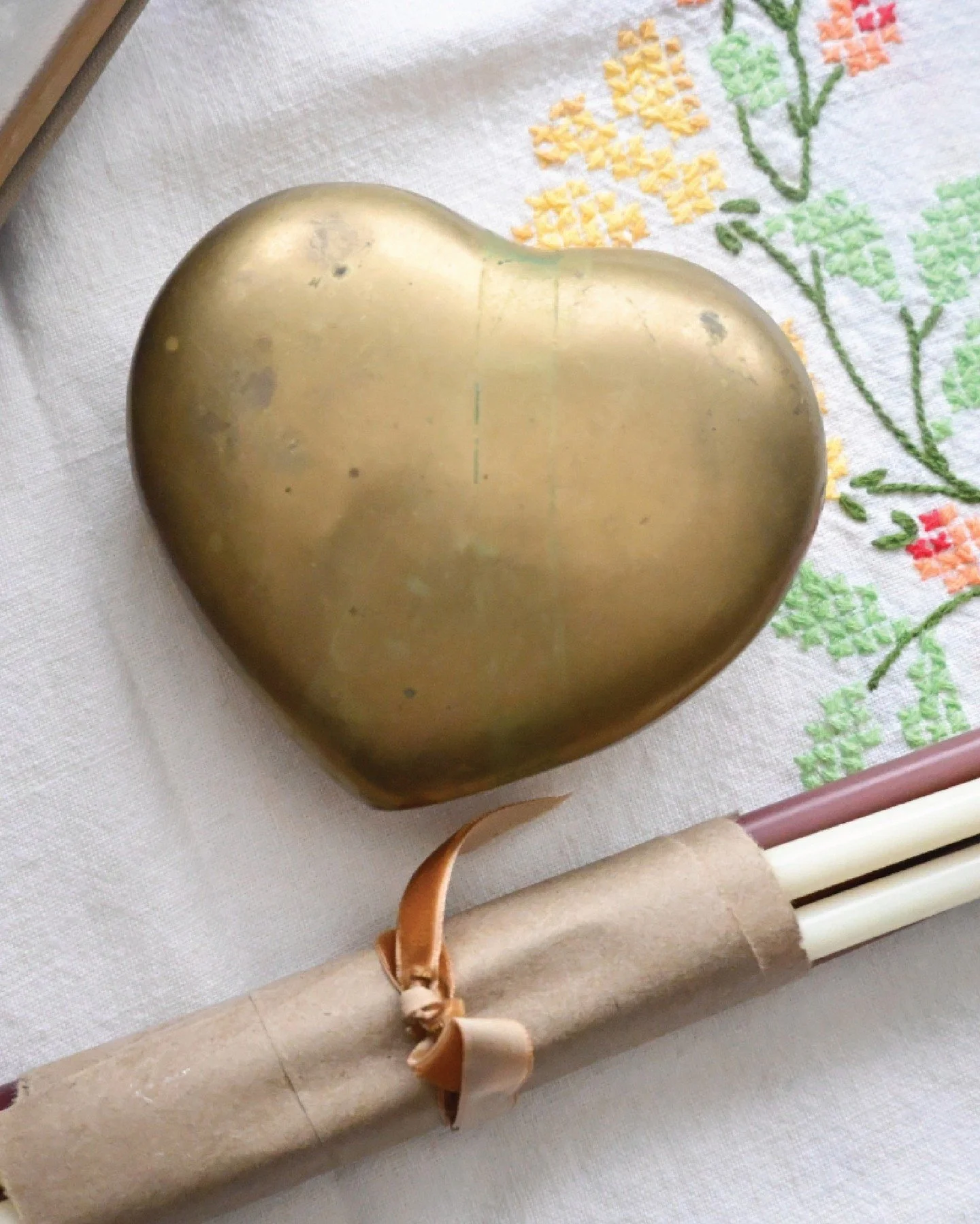 Solid brass heart with honest patina. Holds earrings, paper clips, whatever needs a place.