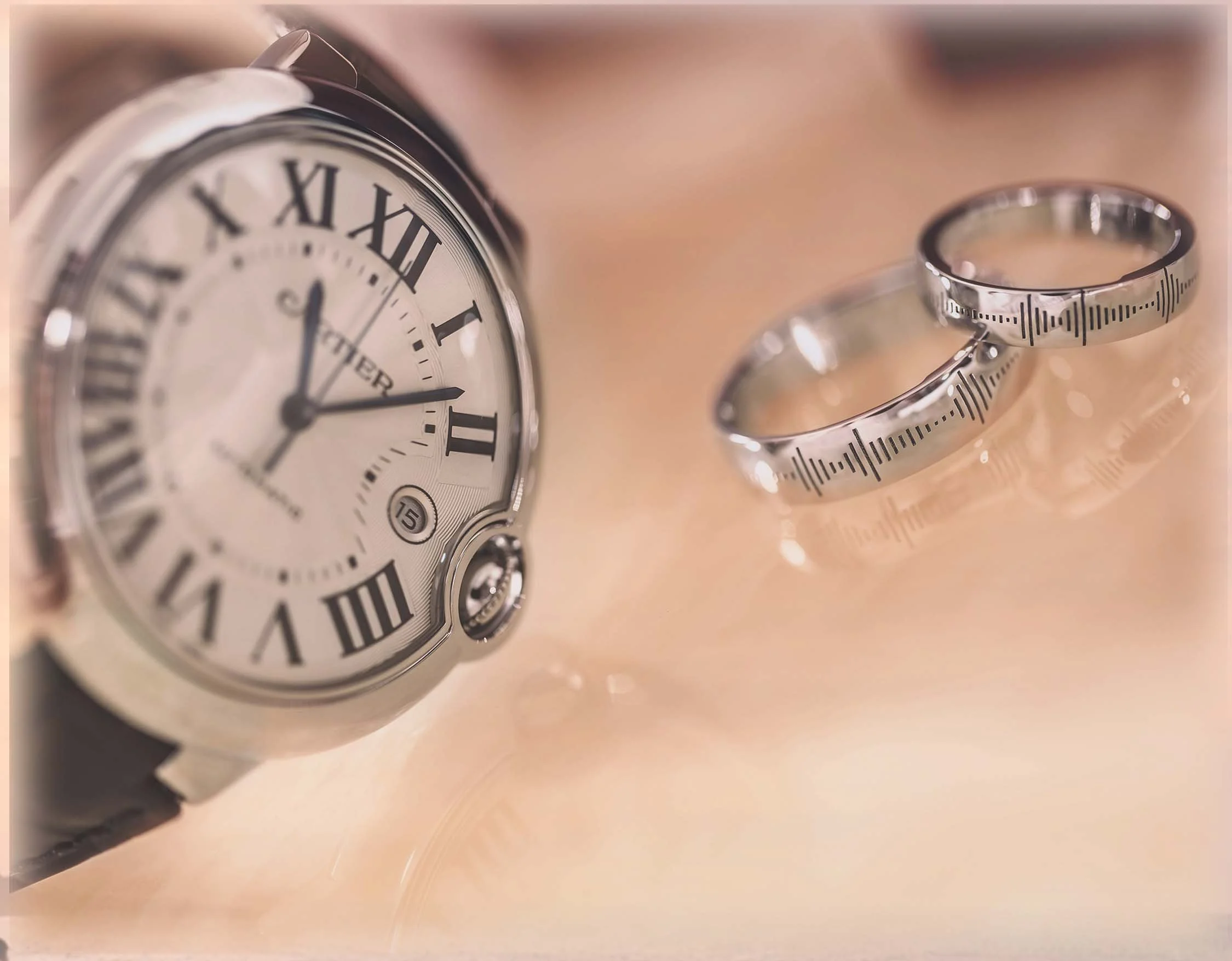 Wedding rings and classic watch symbolizing timeless love and commitment for a beach wedding ceremony by Wedding Knots Tied.