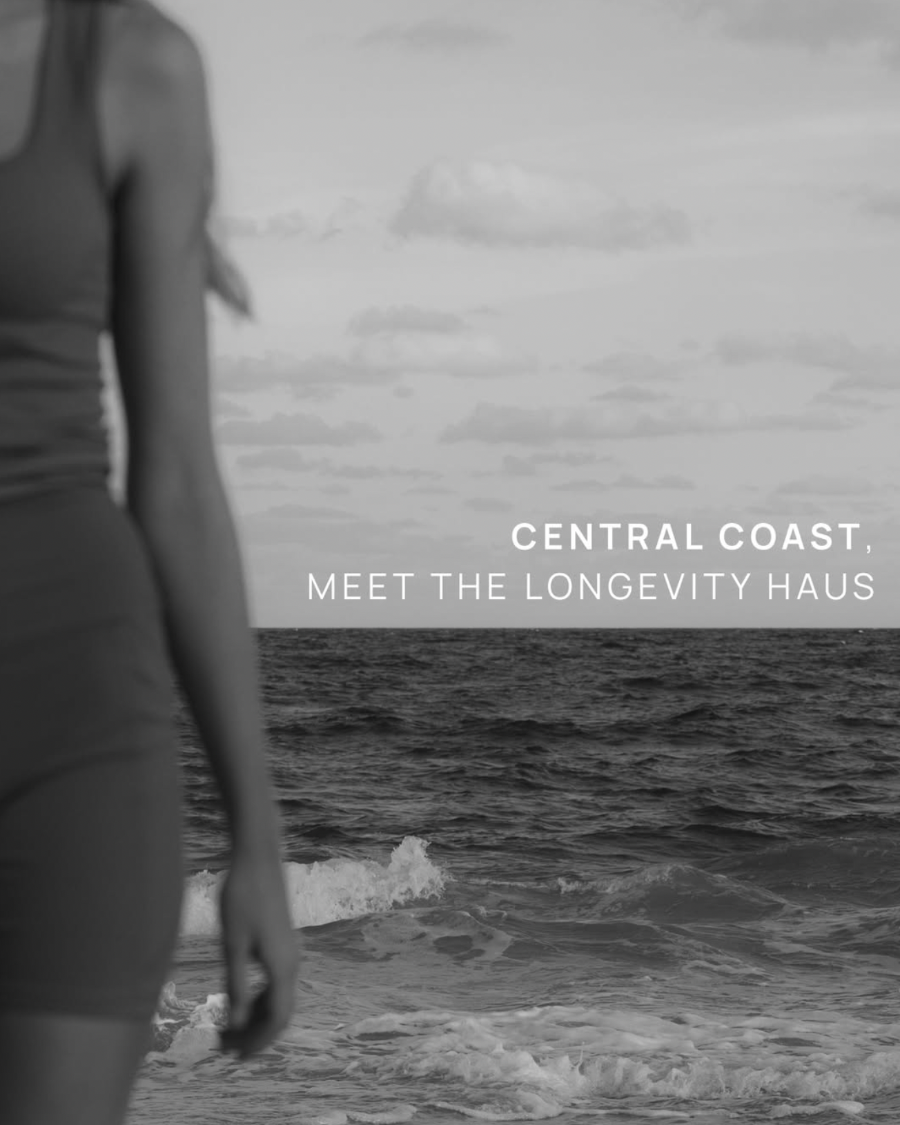 A woman in a swimsuit standing on a beach, with ocean waves and cloudy sky in the background, and text overlay reading 'Central Coast, Meet the Longevity Haus'.