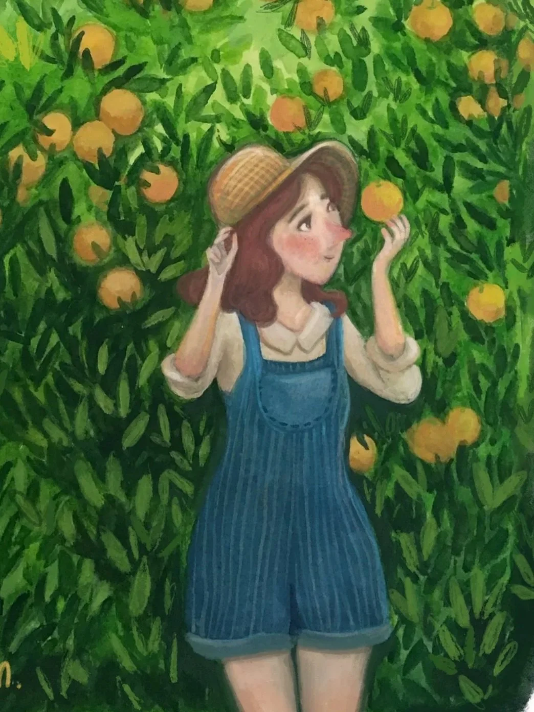 A girl wearing a straw hat, cream-colored blouse, and blue overalls, standing in an orange orchard, holding an orange and looking up at the fruit.