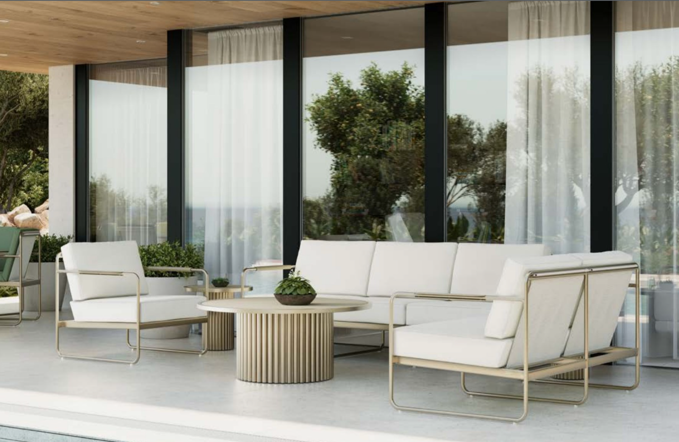 Modern outdoor patio with white cushioned chairs, round beige striped coffee table, potted plants, and large glass windows reflecting trees and sky, under a wooden ceiling.